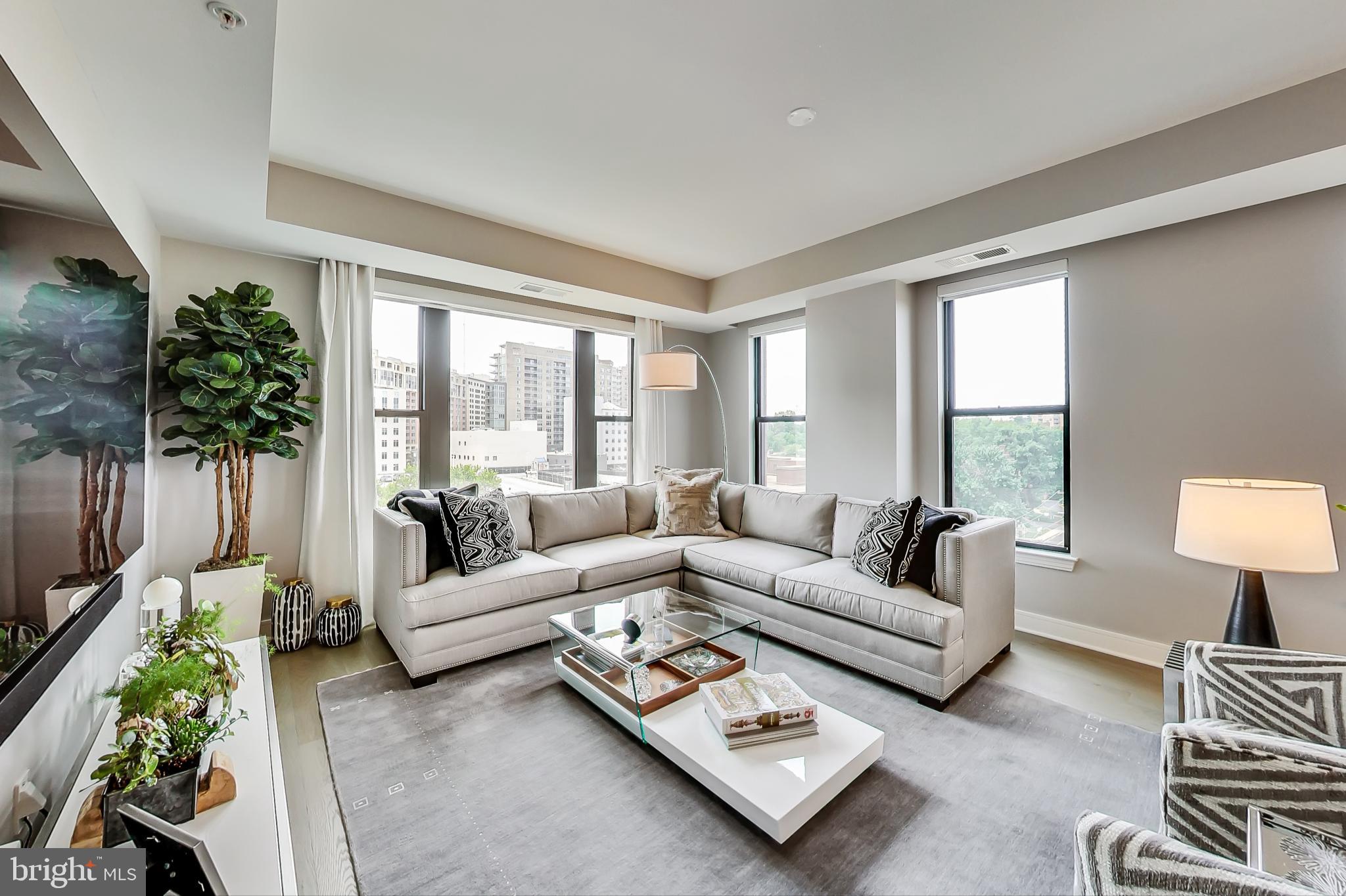 Don't miss this opportunity to enjoy luxurious condominium living at the highly coveted Stonehall in the heart of downtown Bethesda! Take advantage of all the amenities in this boutique, full-service concierge building with downtown Bethesda at your fingertips! Incredible details in this like-new two bedroom, two-and-a-half-bathroom home with one of the best floorplans in the building.
This quiet, spacious home offers an entry foyer, stunning hardwood floors, tons of natural light, and high-end upgrades! The living and dining rooms offer oversized windows with tranquil views and custom motorized shades, a quiet balcony, and beautiful designer light fixtures. Make your way to the kitchen where you will enjoy custom cabinetry, Caesarstone quartz countertops, a separate beverage fridge, and countertop seating. Make use of the huge space adjacent to the kitchen with an informal breakfast area, second family room, or sitting area.
Enjoy the utmost privacy with a split bedroom design. The expansive primary suite features two large walk-in closets and a separate sitting area/home office nook with oversized windows. Enjoy the spa-like primary bathroom offering dual vanities with plenty of storage space, backlit mirrors, walk-in shower, and separate water closet. On the other side of the home you’ll find the second well-appointed full bathroom as well as the second spacious bedroom with a large closet. This unit offers a convenient guest powder room, and a full-size, in-unit laundry room. This home also features custom UV film on all windows!
The Stonehall offers unparalleled amenities, including a state-of-the-art fitness center, multiple rooftop terraces with panoramic views and resident garden boxes, and a private club room with walk-out access to the terraces. Step outside to enjoy the beautiful architecture of the building and all that Bethesda city living has to offer! From Harris Teeter directly across the street to an abundance of restaurants, retail, and more, you’ll find all you need within steps! Just minutes from NIH, Walter Reed, and Metro, providing easy access to downtown D.C., the location and luxury of this home can’t be beat!