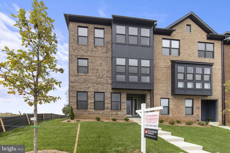 $30,000 TOWARDS CLOSING ASSISTANCE  *Subject to the use of one of the builder-approved lenders.  Can be used for interest-rate buydowns! Restrictions apply.  

Welcome to your new END UNIT home! Situated in the brand-new amenity-rich and walkable neighborhood of Melford Town Center, conveniently located on the junction of Route 50 and 301 in the heart of Bowie, this location is just minutes away from Bowie Town Center, and a short commute to Washington DC, Annapolis, and Baltimore! This stunning two-car garage luxury townhome built by Mid-Atlantic Builders features three bedrooms, two full bathrooms, and two half bathrooms.  
Meticulous attention to detail is apparent as soon as you walk through the covered stoop entrance into the home complete with 9-foot ceilings, oak staircases, and black-trimmed Anderson windows that are thoughtfully installed throughout the home.  You’ll be greeted on the ground level by an oversized open rec room with a full bath.  Enjoy relaxing or gathering by the massive 15-foot kitchen island with a spacious living room, dining room, and expansive covered terrace. The third level is complete with a primary owner’s suite with an oversized spa shower and two secondary bedrooms with walk-in closets and a dual vanity hall bath, with a coveted bedroom-level laundry room.  Tremendous care has been taken architecturally to design multiple brick front exteriors that create variation but harmony amongst the units as well as the overall community.  To that end, each unit is constructed with varied elements such as canopies, window groupings, bays, front gables, and dormers to provide interest along the streetscapes.  *Must see!