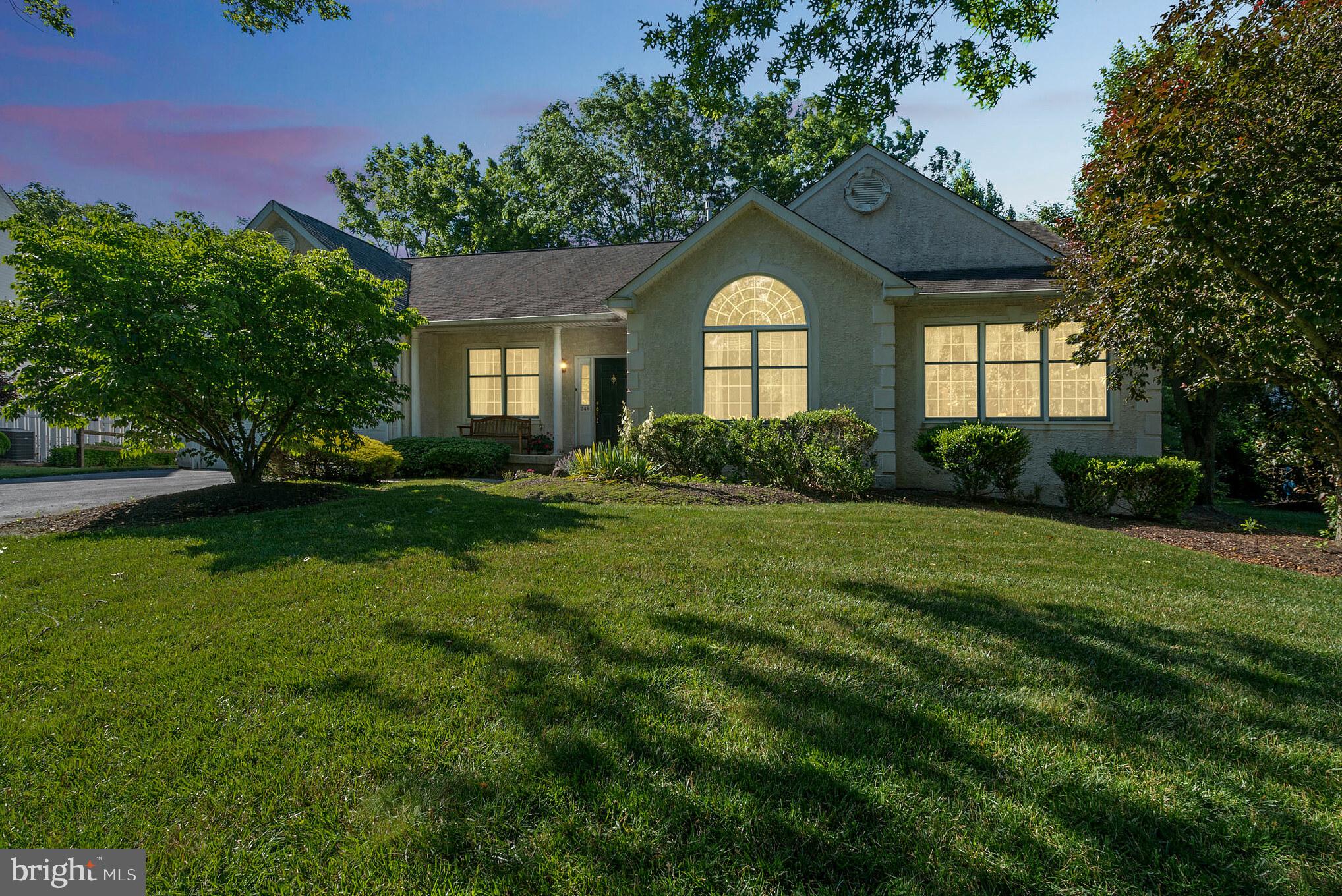 Welcome to 248 Hidden Den Circle, a gracious, charming, and spacious 3 bedroom, 2 bath single-story home offering 2,443 square feet of living space in a beautiful park-like setting. Entering the home, you will notice the gleaming hardwood floors and high ceilings. The spacious formal living room features a fantastic large-scale arched window bringing the natural light and beauty from the outdoors. Across the hall, you’ll find the dining room with an entrance into the kitchen providing ease of entertainment. You’ll love the separate room behind french doors for privacy which can be used as a study or a 3rd bedroom. The kitchen, with its ample cabinetry and walk-in pantry, is open to the family room and breakfast room. The family room features a floor-to-ceiling stone gas fireplace, high ceilings, and a ceiling fan. The breakfast room is sure to please with a high ceiling, ceiling fan, and skylights. It is surrounded by windows and has sliding glass door access to the deck with an electric awning, gardens, and a sprawling storybook lawn beneath the trees. The spacious primary bedroom with sitting room is large with high ceilings and recessed lighting, plus a spacious walk-in closet. The ensuite bathroom features Corian countertops, dual vanity sinks, a garden tub, and a standalone shower and skylights. Down the hall, you find 2 additional bedrooms, a full bath, and a laundry room. There is a large, finished basement, offering the perfect spot for a family room, play area, or storage space. You’ll also notice the 2 car garage with lots of space for storage. This home is near Kids Castle Central Park, Delaware Valley University, and the Doylestown Hospital. You’ll also find schools, dining, shopping, and a train station in close proximity to Doylestown and you’re only a 15-minute drive to Peddlers Village!  A new water heater was installed this year, there is a whole house water softener and a central vacuum system! This home won’t last long. Don’t wait, schedule your showing today.