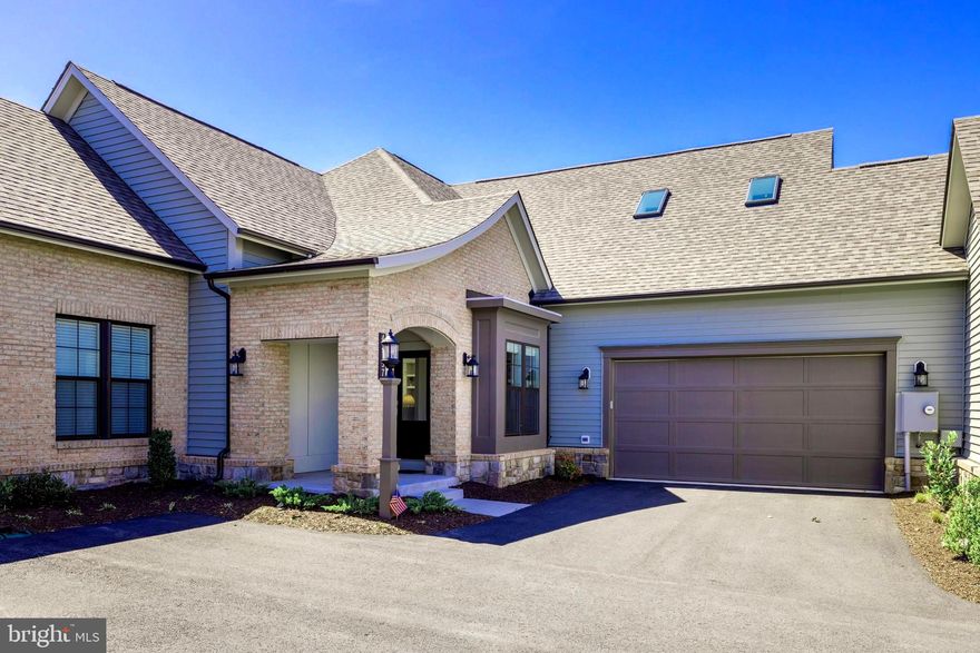 STUNNING nearly new Miller & Smith Crescendo model Villa in the sought-after Birchwood 55+ Adult Community in Brambleton. No detail has been missed! Enjoy MAIN LEVEL LIVING with a wide-open floor plan, special features and custom finishes throughout. The GOURMET KITCHEN boasts upgraded GE Café Smart Stainless Steel Appliances, Quartz Countertops with an oversized Island, upgraded soft-close Cabinetry, custom Backsplash, Wine/Beverage Cooler and a spacious Pantry. The extended DINING AREA (structural bump out) includes additional buffet cabinets with shelving that leads to your private SCREENED PORCH with Ceiling Fan and Fenced Backyard (***HOA mows inside fence for you...they also plow your long driveway!) The GREAT ROOM features beautiful Hardwood Flooring, custom Beamed Ceilings, custom Gas Fireplace with Remote and in-floor electrical outlets. The spacious FOYER is accented by a custom 'design wall’ that separates the dedicated OFFICE/DEN. The PRIMARY SUITE is full of light and includes an oversized Bedroom, lighted Tray Ceiling, Crown Molding and an enormous Walk-in Closet. The En-suite Bath features HEATED FLOORS, a double Vanity with Quartz Countertops, upgraded soft-close Cabinetry, Frameless Shower with built-in Seat & Rain Shower head, PLUS a Linen and private Water Closet. LAUNDRY: Front-Load Washer/Dryer, Utility Sink, Custom Barn Door and an additional Window allows for even more sunlight!  The UPPER LEVEL Loft features Hardwood floors, custom Wall Shelving, a Vaulted Ceiling and Skylights. Also upstairs is another spacious Bedroom, Full Bath with Linen Closet, an extended STORAGE ROOM PLUS a separate Utility Room. The GARAGE is fully-decked out with custom Garage Organization System, Hot & Cold Water Spigot and Epoxy Flooring. MORE SPECIAL FEATURES: All Solid Core Doors throughout, Whole Home Central Vacuum, integrated Security Camera System, Whole Home Humidifier/High Efficiency Air Filtration, Plantation-style Blinds throughout, additional Recessed lighting throughout, PLUS an Irrigation System and extended Downspouts with popups in the Fenced Backyard.