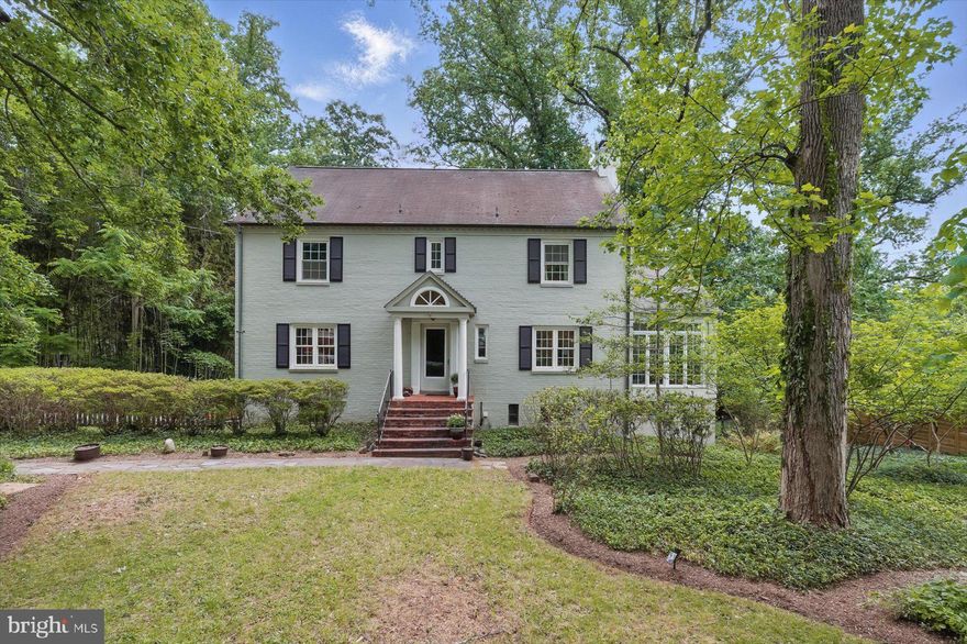 Tucked away on nearly half an acre of lush, private land in the desirable Bannockburn Heights neighborhood, this classic 5-bedroom, 4-level Washington colonial combines timeless charm, exceptional 1941 craftsmanship, and expansive living space. The light-filled home features a gracious main level ideal for both entertaining and everyday living, including a formal entry hall, living room with wood-burning fireplace, sunroom with cathedral ceilings and deck access, elegant dining room, table-space kitchen with a second deck, and a quiet office with an updated half bath. Upstairs offers four corner bedrooms, including a serene primary bedroom overlooking the backyard with three closets and an en-suite bath, plus a second full hall bath. The finished attic, with high ceilings, dormer windows, and built-in bookshelves, provides flexible space for a home office or guest retreat, while the walk-out lower level includes a bright recreation room with fireplace, a fifth bedroom, full bath, and laundry area connecting to the two-car garage. Outdoors, the flat, tree-lined backyard is perfect for gardening, play, or relaxing, and includes a large shed and additional storage beneath the kitchen deck. With a long driveway, turnaround, and bonus parking, the home offers comfort and convenience. Located along the scenic MacArthur Boulevard corridor near trails, parks, Glen Echo, Cabin John, and top-rated schools including Walt Whitman High School, this property presents a rare opportunity in a sought-after neighborhood.