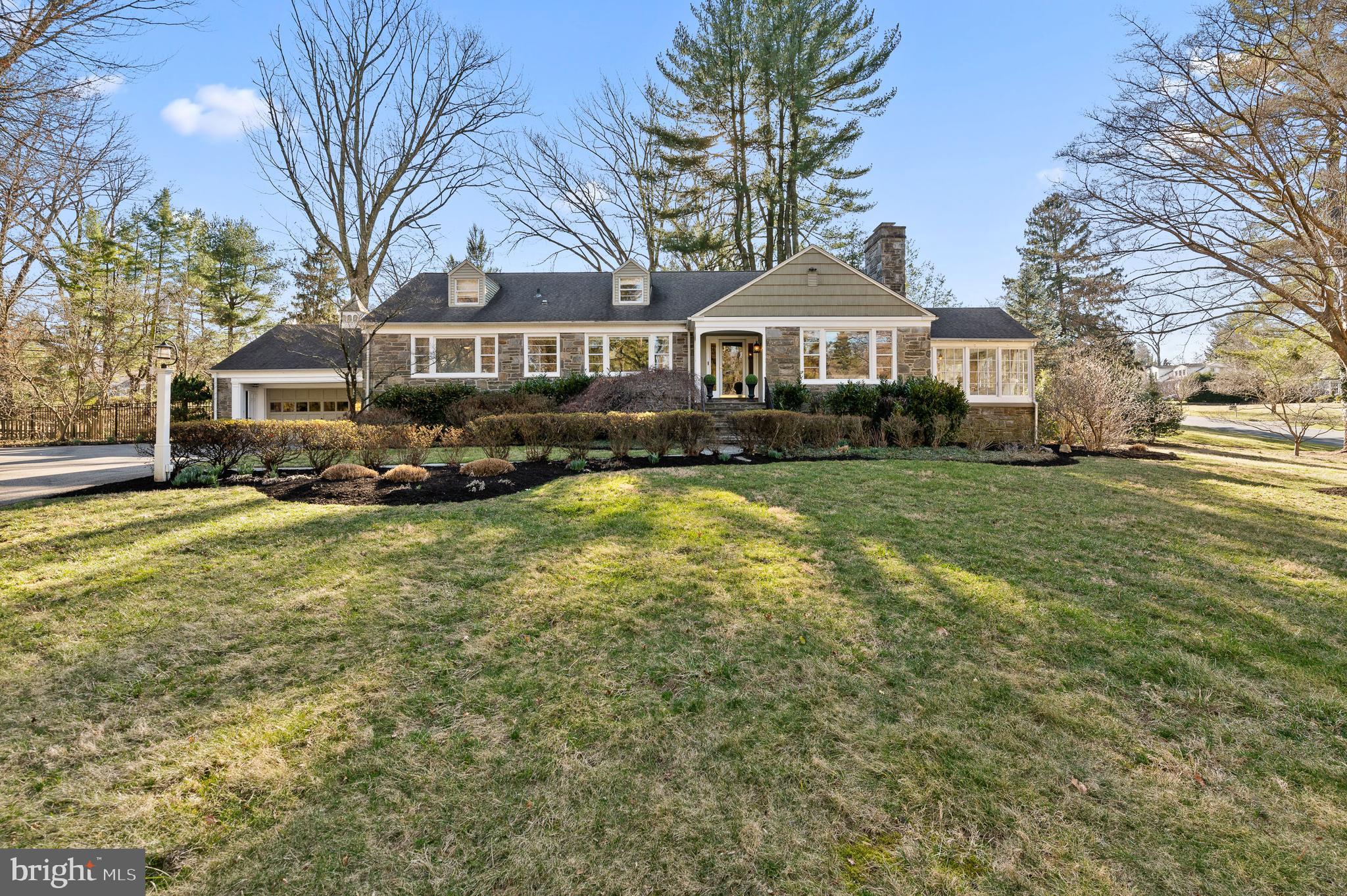 A picturesque and turnkey gem in one of Lower Merion's most sought-after neighborhoods. Welcome to 316 McClenaghan Mill Road, built by Mahoney builders. This gorgeous 5 bedroom, 3 full/1 half-bathroom stone cape colonial is situated on a .95 acre flat corner lot of sprawling landscaped grounds. In addition to this home having a premier convenient location, it is also located in the high school choice zone of Lower Merion School District! As you walk up the stone path and enter the home, prepare to fall in love! Gleaming refinished oak floors run throughout the first floor. Enter into the welcoming foyer, and to the right is an extra large living room with a beautiful wood-burning fireplace and the finest moldings. This living room flows directly into a sunlit dining room. Off of this living room is also a seasonal light-filled porch with full glass windows that can be replaced with screens during the warmer months. The back of the home continues with an open and airy flow into a large eat-in kitchen with two-toned cabinetry, a cherry finish island with a butcher block top, neutral granite countertops, tile backsplash, a butlers pantry with sink, undercabinet lighting and plenty of storage. Directly off the kitchen is an enormous family room offering abundant light. This "great" room boasts custom built-in cabinetry/shelving, a beautifully pointed stone wood-burning fireplace, custom Anderson windows and doors, vaulted ceilings, and skylights. Open the glass doors directly out to the tiered deck to your very own private, tranquil oasis completely fenced in! This space is perfect for a quiet relaxing evening, or summer barbeque! The main floor also has a large primary bedroom, with great closet space. The ensuite bathroom includes an oversized shower, a porcelain tile floor that extends to the shower walls, and a white double vanity with Carrara marble countertops! There are two additional bedrooms and a full bathroom on the first floor. With so much functional space in this home, the current owners used one of these bedrooms as an office. The second floor has two extra large bedrooms and a Jack and Jill bathroom One of these bedrooms is currently being used as an au pairs room. The large full basement offers great potential and additional living space, complete with a powder room and laundry area. The basement will also lead you to the attached garage. 316 McClenaghan Mill Road is in an ultra-convenient location with just over a mile walk to Suburban Square, Trader Joe's, Whole Foods, and two different SEPTA stations making it a commuter's dream! This absolute GEM is close to everything and has it ALL!