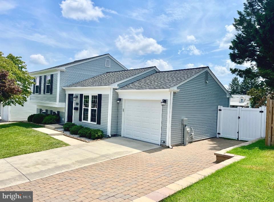 Beautiful brand-new renovation! New paint, trim, flooring, doors, and hardware. New kitchen includes quartz countertops and a beautiful tile backsplash with stainless steel appliances. Open concept living room has shiplap and gorgeous crystal electric fireplace with heat. Both full bathrooms have ceramic tile and brushed nickel hardware and fixtures. Enjoy the large owner's suite with sliding doors to rear deck. New washer and dryer. This is truly a turn- key home. Backyard offers a wonderful privacy fence and huge outdoor patio, great for entertaining! Large shed. One car garage with double wide driveway for additional parking space and a water privileged neighborhood with marina and boat ramp. Free one year warranty in addition to all the manufacturers warranties. Easy commute to Baltimore and close to major highways and shopping. Come see this beautiful home before it sells - you won’t be disappointed.