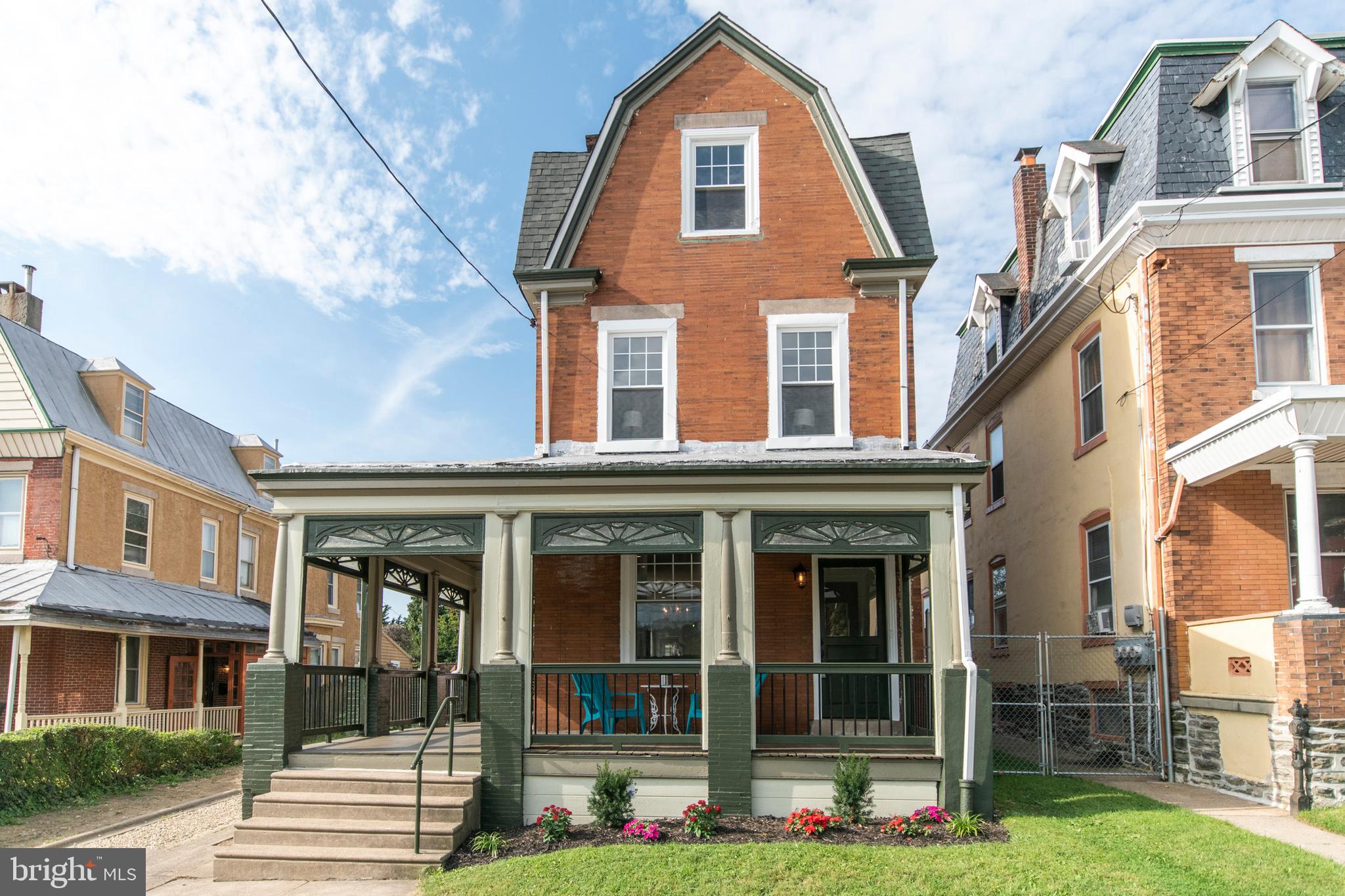 This grand single home stands tall and proud on a quiet Germantown street.  And proud it should be beautifully restored inside and out, this home boasts one-of-a-kind design details and high-end finishes merged with original character throughout.  Park in the driveway and the first thing you will notice is the covered wrap-around porch, welcoming you to come up and have a seat and relax.  But don't stop there, then take a deep breath and open the front door. You'll find yourself in the original vestibule; then open the restored frosted glass door and take it in everything from the gleaming original hardwood floors, the high ceilings with recessed lighting, the large dining area, and the natural light streaming in from the abundant new windows.  Next, have a seat at the breakfast bar accented by a salvaged beam and custom glass pendants overhead and absorb the gorgeous kitchen: blue fantasy granite countertops, farmhouse sink and stainless steel Frigidaire appliances, under-cabinet lighting, and ooooh that beautiful blue-green tile backsplash! The mudroom in the back houses the washer and dryer, tucked away beneath a sleek counter custom-crafted out of locally-sourced barn wood. There is also a half bath, tucked neatly behind a pocket door. Then the back door leads to your giant parking/yard/party/play area an--wait for it--a TWO-CAR DETACHED GARAGE with additional storage. This area is enclosed by a wood privacy fence. Keep going, back inside and up the stairs because there is much more to see. At the top of the stairs, a sliding barn door leads to the hall bath with marble floor and restored original cast iron tub.  Next to it is the first of four light-filled bedrooms, all with ceiling fans; the master suite is at the other end of the hall. Inside, another sliding barn door separates the bedroom from the his-and-her closets leading into the large spa-inspired bathroom, featuring a marble-top double vanity and glass-enclosed shower. The third floor has two more large bedrooms.  The large basement is dry, and has been freshly painted and sealed. All new mechanicals, plumbing, electric, roof.  And, although this home has parking beyond your wildest dreams, it is also an easy walk to the SEPTA train.