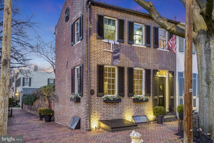 The absolute best Old Town has to offer! Step into this beautiful historic home dating from circa 1800, offering two bedrooms, two full baths, stunning walled gardens, and a coveted one car garage. 325 Queen Street, located in the center of Old Town and three blocks from the Potomac River, has been meticulously  renovated. The handsome Living Room presents with a gas fireplace flanked by generous built-in shelving and windows on three sides allowing bright sunshine, as well as privacy with custom made shutters. Towards the back of the home is the elegant Dining Room with gas fireplace, recessed lighting,  and shelving opening to the light and bright kitchen. The lovely kitchen, featuring Italian ceramic floor tiles and accents, is fully modernized with top of the line appliances, including a large sub-zero refrigerator, but also retaining the charm of the era with a large bricked fireplace which served as the original cooking hearth! Kitchen space is abundant for the gourmet chef, as well as relaxing with friends on the charming window seat, next to the patio door dating from 1790! The peaceful and bright Primary Suite is located on the upper level, with decorative fireplace and generous closet. A separate  sitting room with a gas fireplace and second bedroom, featuring a Thomasville Captain's Bed,  are also on this level. Downstairs is a beautifully done Family Room with lush carpeting, a full bath and plenty of storage. The crowning jewel of this home is the walled English garden, which has been the scene for countless garden parties and small al fresco dinners. Complete with outdoor and accent  lighting and gorgeous hardscape, it is truly a haven of peace. Through the gardens is the one car garage - a rarity for historic homes in Old Town. WINNER OF THE 2018 HISTORIC PRESERVATION AWARD !  **Please note estimated total square footage 1850SF**