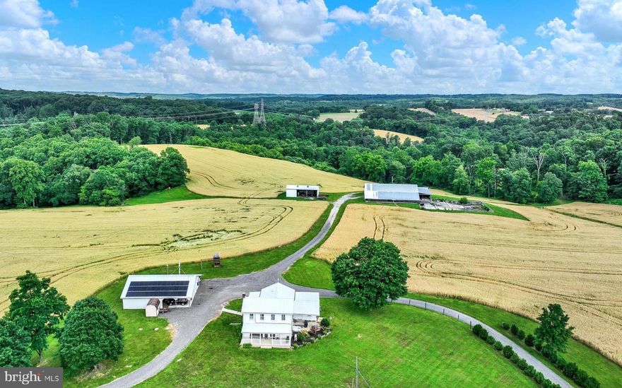 Welcome to the epitome of rural living in the heart of Northern Baltimore County's prestigious Hereford Zone. Nestled on a sprawling 149-acre farm, this property offers a splendid farmhouse experience with modern amenities and abundant space for both living and cultivation. The main farmhouse boasts 3 bedrooms and 2 full baths, adorned with charming exposed ceiling beams and classic wood floors throughout. A spacious country kitchen serves as the heart of the home, perfect for gatherings and culinary adventures. Additionally, the attached in-law quarters provide private accommodation with 1 bedroom and 1 full bath, ideal for multi-generational living or guest quarters. The in-law quarters offers a separate ramped entrance. This well maintained property features central air conditioning, replacement windows, and an updated kitchen, ensuring comfort and convenience. Outside, a detached garage/workshop equipped with an electric hydraulic lift offers ample space for vehicles and projects.
For the equestrian enthusiast or hobby farmer, anticipating having livestock,  the expansive grounds include a 110' X 70' barn with 13 stalls, previously utilized for beef cattle, and a 54' X 30' equipment shed. Approximately 70 acres (+/-) of tillable/pasture land provide opportunities for farming or grazing, while 60 acres (+/-) of wooded terrain offer tranquility and natural beauty. As a bonus, the property benefits from solar panels (currently leased and transferable), offering sustainable energy solutions and potential cost savings. A stream meandering through the landscape adds to the picturesque setting, enhancing the property's allure. Situated in the highly sought-after Hereford School Zone and enrolled in the Maryland Agriculture Land Preservation Foundation (MALPF) easement program, this farm presents a rare opportunity to embrace a serene lifestyle while preserving the rich agricultural heritage of the region. Don't miss your chance to own a piece of paradise in this coveted locale. Schedule your private tour today and experience the charm and potential of this remarkable Hereford Zone farm. This property is ineligible for subdivision.