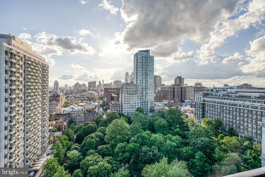 Enter through the double doors to a spacious foyer that leads you into your large dining/living room with and additional family room/den area. In the foyer there is a large walk-in closet. Spacious kitchen with plenty of cabinetry for storage and countertop eating. There is a Large walk-in laundry room with full-size washer and dryer plus storage. Entertain in your Large dining room that opens up to your very spacious living room with a wood-burning fireplace. Off the living room there is a Large deck that faces north and west with a full view of Washington Square Park, plus a south west view for magnificent sunsets. There is an east view of the Ben Franklin bridge and a full water view. In the living room there is an enclosed built in wet bar with lots of cabinetry for all your entertaining needs, plus a wall of built-in bookshelves. Off of the living room there is a spacious home office. Before you enter the master bedroom, there is a large double door closet for additional storage. When you enter the large master bedroom there are three large closets, one that is a walk in and a wall of built-ins with drawer space and shelving, no additional furniture is needed. From the bedroom you will enjoy a beautiful east view of the bridge and the river. The master bathroom has marble tile floors, a very large sink and vanity with lots of storage, plus a make up area, a linen closet, a large walk-in shower, plus a Jacuzzi sunken tub. On the other side of the unit, for privacy, there is a second bedroom and a full guest bathroom. The bathroom has marble flooring, granite tile sink and a large walk in tile shower. The second/guest bedroom is extra large with a full wall of closets and an additional built-in TV/storage unit. You will enjoy the southwest views of the park and the beautiful sunsets. This is a spacious, high floor condo with central air in a prestigious, highly sought after building. There are not many units in this building that enable you to have multiple views from your large balcony with ample living space. This home  is heated and cooled by electric heat pump. Condo fee is $1427.81, TV/Internet charge is $73.00, Electric is $211.00 (adjusted at end of year based on usage)