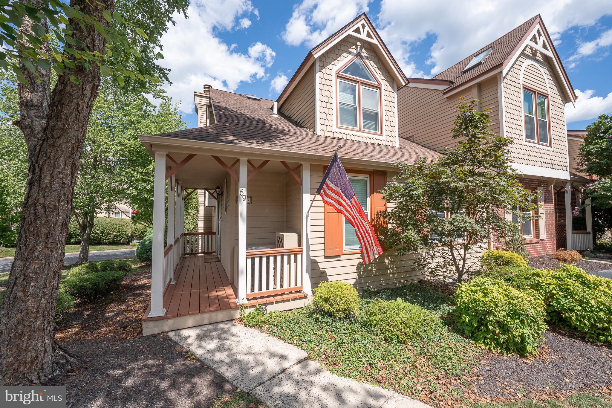 Welcome to 69 Main Street, a charming two-bedroom end-unit townhome that offers comfort, convenience and style. Located in Chesterbrook's desirable Main Street Village, this home includes a rare first-floor bedroom and bath. Step onto the welcoming front porch and into the foyer, featuring hardwood floors, a spacious coat closet and a turned staircase. The first-floor bedroom includes a large closet and connects to an updated bath with tile flooring, a granite vanity and a tub/shower with a full tile surround. The kitchen is thoughtfully designed with stainless steel appliances, a pantry, granite countertops, a brick backsplash and a breakfast bar that opens to the great room. The great room combines living and dining spaces, accented by hardwood floors, a vaulted ceiling with skylights, ceiling fans and a gas fireplace. Two sets of French doors lead to a new deck, perfect for outdoor gatherings. Upstairs, the primary suite features a vaulted ceiling with skylights and ceiling fan, along with a Juliet window that overlooks the great room. A cozy alcove provides the perfect reading nook, and the large walk-in closet ensures ample storage. The updated ensuite bath includes double sinks with granite countertops, a soaking tub, a spacious walk-in shower with tile surround and a tile floor. The walk-out lower level offers additional living space, including a built-in workstation, wet bar, an updated powder room, double doors leading to a private patio, a laundry room and two large storage rooms. This lovely home is part of the award-winning Tredyffrin/Easttown School District and the Chesterbrook which offers miles of walking trails, beautifully maintained common areas and nearby parks for outdoor enjoyment. Shopping, dining and cultural attractions of the Main Line are moments away, while major roadways including Routes 202, 422 and the Pa Turnpike provide easy access to Center City Philadelphia, King of Prussia and beyond.