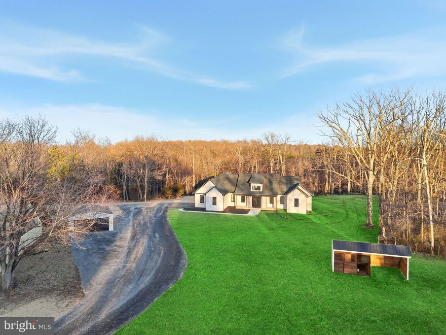 Experience One Living Living at Its Finest! Builder has included many custom features to include partial stone front, 51" kitchen cabinetry with partial glass fronts, quartz counter tops, custom hood, marble flooring in owner's bathroom , composite back covered porch with cedar posts, black railings and ceilings a , fireplace with stone surround, LVP on main level, and much more. Nestled on 14 scenic acres with a peaceful mix of open land, woods, and a small stream, this new custom-built rambler offers the perfect blend of privacy, beauty, and convenience — all just minutes from downtown Culpeper and with no HOA. Step inside and be welcomed by more than 2,400 square feet of thoughtfully designed one-level living. The open floor plan features 9-foot ceilings throughout, a dramatic vaulted ceiling in the great room, and elegant tray ceilings in both the office and the owner’s suite. A striking double see-through fireplace connects the great room to the expansive 39x12 covered porch, creating the ideal space to entertain or relax while taking in the views of your land. The heart of the home is the gourmet kitchen, designed with both function and style in mind. Gas cooking, a large island, upgraded countertops, and shaker-style soft-close cabinetry make it a chef’s delight. The adjoining dining area and open living spaces flow seamlessly, creating a warm and welcoming atmosphere for gatherings. The luxury owners suite is a true retreat with a spacious walk-in closet and spa-like bathroom featuring custom tiled shower and free standing tub. Two additional bedrooms and a well-appointed full bath provide space for family or guests, while the unfinished basement with rough-in offers endless potential for future expansion — whether you dream of a recreation room, home theater, or guest suite. Outdoors, the property is designed for those who love space and flexibility. Already in place are a Morton building run-in shed and a large metal garage, perfect for equipment or vehicles. With plenty of room for horses, goats, chickens, or gardens, this property invites you to bring your vision of country living to life. And unlike most rural properties, this home offers the rare convenience of natural gas and high-speed internet — giving you modern comfort without sacrificing the charm of a country lifestyle.  Home is Completed!