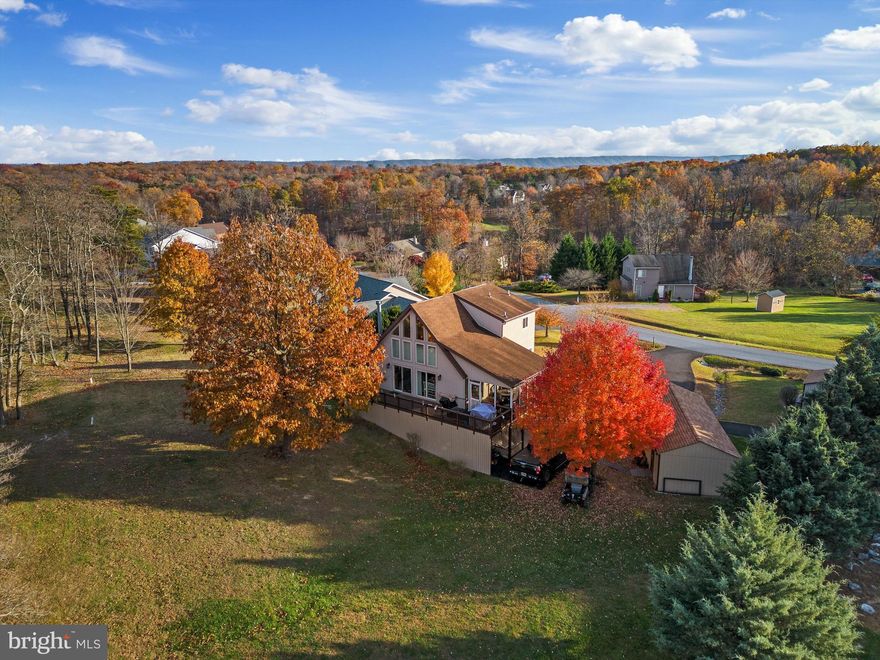 Discover the charm of living on a serene golf course with stunning views! This immaculate 4-bedroom, 3-bathroom home on the 10th fairway offers three finished levels, a 12X17 screened-in porch, a cozy gas fireplace, beautiful hardwood floors in the living room, kitchen, and dining area, and carpet in all bedrooms.  A large owner’s suite is located on the 2nd level, 2 bedrooms are on the main level and the 4th bedroom, along with a family room and laundry room are located on the lower walkout level.  Each floor has a full bath as well. With vaulted ceilings, exposed beams, and lots of natural light throughout, it is a must-see for those seeking comfort and beauty in every detail. There is plenty of parking for your guests in the huge circular driveway and there is also a detached one car garage and shed for your storage or golf-cart needs.  NEIGHBORHOOD DETAILS: The Woods affords year-round recreation, and varied activities — all in a quiet and well-governed community located within 90 minutes of Washington D.C. *** Available with this unit is a Class B membership opportunity for The Woods Club- for an additional initial fee and annual dues. Private Club Amenities include: Golf (Greens Fees), Driving Range, Chipping Green, Putting Green, Indoor Sports Center (racquetball, indoor pool, gym, aerobics room, laundry facilities, sauna, steam room, whirlpool, volleyball, indoor & outdoor tennis, indoor & outdoor basketball, shuffleboard, pickleball), 2 outdoor pools, clubhouse, club room, baseball field, playground, and fishing ponds. Other onsite amenities include the Clubhouse Grille & Pub and the Sleepy Creek Spa & Salon. Nearby is the Sleepy Creek Wildlife Management Area that offers outdoor adventures like hunting, fishing, and hiking. Whether a part-time or permanent resident, enjoy the serenity of your own private retreat and all The Woods and the surrounding area have to offer!