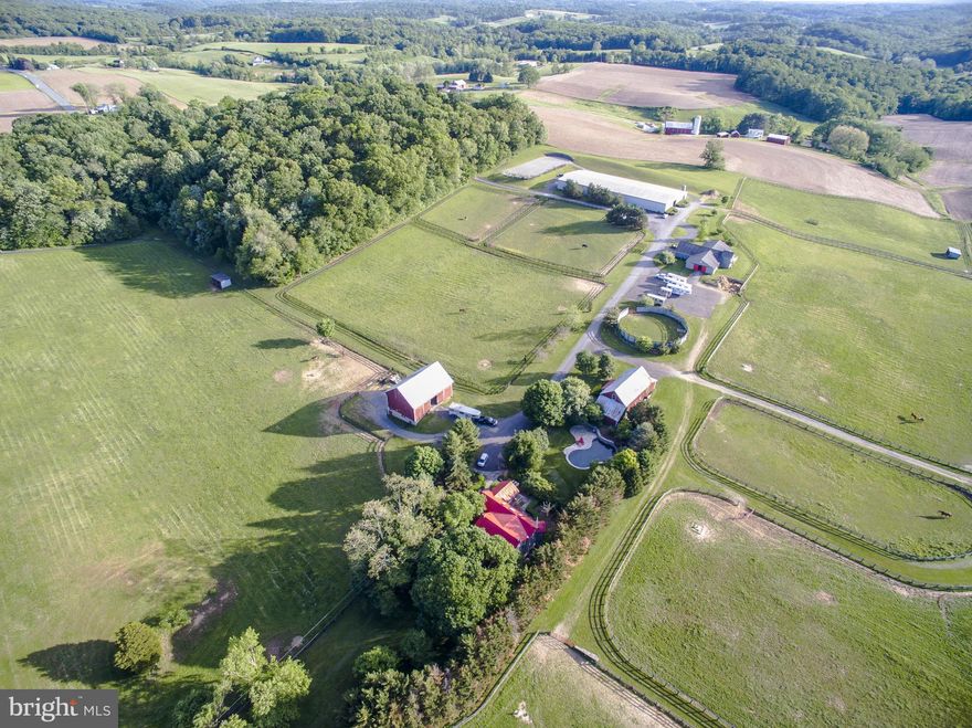 An outstanding equestrian/training facility located in the heart of Baltimore County horse country. Lighted indoor arena; outdoor dressage ring; outdoor 125 x 225 jump ring; 75' diameter round pen; 40 jump cross country schooling course w/water; 35 12 x 12 rubber matted stalls; 3 tack rooms; hot water wash stalls; lush turnout; guest house & barn apartment; main house w/pool.