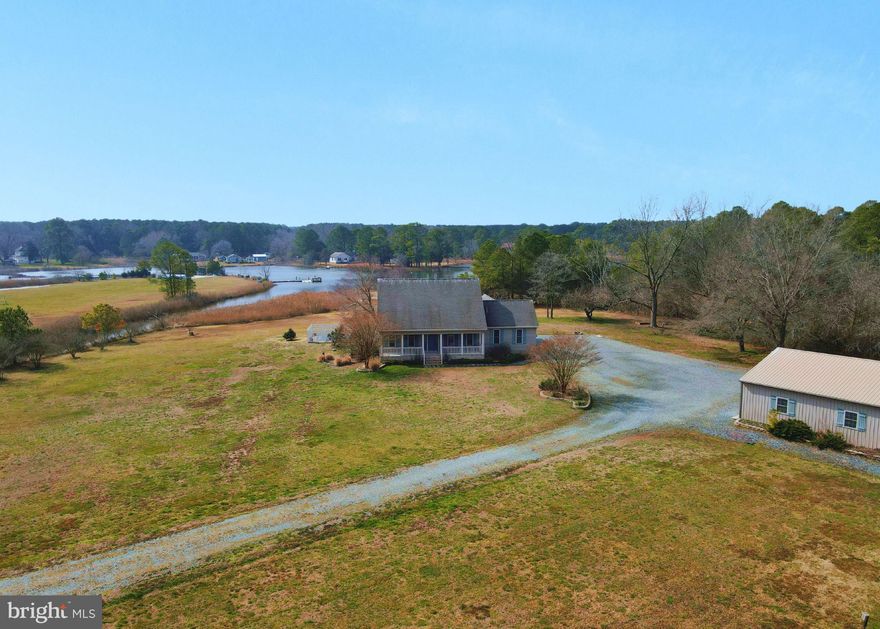 Welcome to your dream waterfront escape! Nestled on 4.8 acres of prime real estate, this captivating 4-bedroom, 2-bath Cape Cod residence adjoins Colbourne Creek with direct access to the breathtaking Tangier Sound. Inviting front porch leads to a spacious Living Room with built-in pallet stove.  Spacious first-floor primary suite with panoramic waterfront views, a large bathroom featuring a whirlpool tub, walk-in closet, and sliding glass doors leading to the deck – the ideal spot to witness stunning sunsets. Versatile upstairs area currently serving as a bedroom, family room, and recreational room – offering flexibility for customization (potential for a fifth bedroom, additional bathroom, or in-law quarters with minor modifications). 
The great outdoor space features a fenced in-ground swimming pool, a composite back deck with an electric awning, a 36x36 pole building with electric and water, and an extended driveway. A 100 ft. pier completes the waterfront experience, featuring a 20' end with a 10,000 lb. boat lift and a two-space floating jet ski dock, fully equipped with electric and water. This residence seamlessly combines comfort, functionality, and stunning views, making it an ideal haven for those seeking a peaceful retreat or a boater's paradise. Contact us today to arrange a private tour and make this waterfront gem your own.