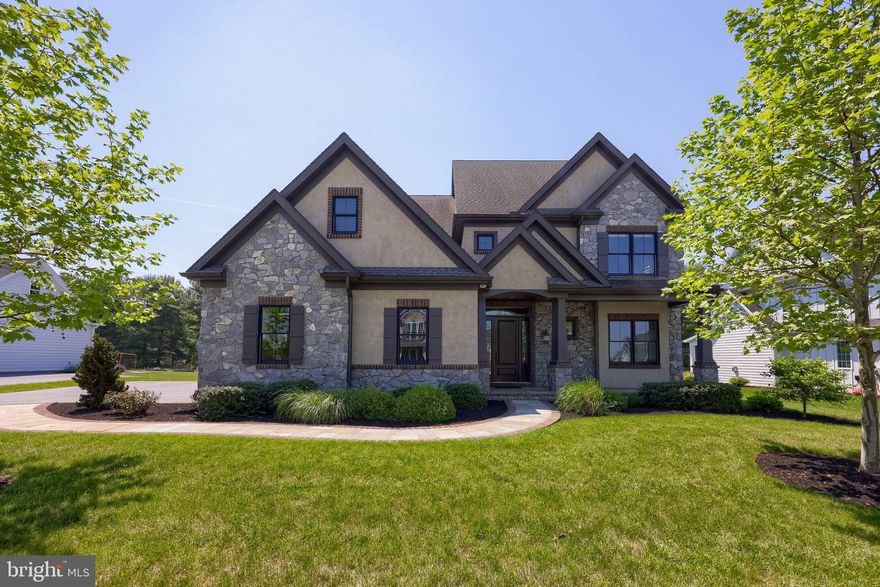Welcome to this exceptional four bedroom, three and half bath home located in Stonehenge Estates community of Manheim Township, a property that perfectly balances luxury with everyday livability. From the moment you step inside, you are greeted by a grand foyer highlighted by a stunning pendant light, elegant coffered ceilings, and engineered hardwood flooring that flows seamlessly throughout most of the main level. Expansive windows fill the home with an abundance of natural light, creating bright, inviting spaces that transition effortlessly from one room to the next.
Just off the foyer, the front room easily function as a sophisticated sitting room or office, featuring built-in shelving, detailed wainscoting, and crown molding. The formal dining room offers an elegant setting for entertaining tray ceiling, glass-door cabinetry, recessed lighting, and refined architectural details.
The heart of the home is the spacious family room centered around a fireplace, perfectly positioned adjacent to the gourmet kitchen for comfortable everyday living and entertaining. The kitchen is thoughtfully designed with a large island, wet bar, under-cabinet lighting, and premium JennAir appliances including a double-door refrigerator, wall oven, wall microwave, five-burner cooktop, and dishwasher. Sliding doors open to a screened-in porch and patio area complete with a convenient gas line for grilling, extending your living space outdoors with ease.
Additional features on the main floor include a powder room, first-floor laundry room, an attached three-car garage, and a separate one-car garage for added flexibility.
Upstairs, the luxurious primary suite offers a private retreat with engineered hardwood flooring, crown molding, a spacious walk-in closet, and a spa-inspired bath featuring a soaking tub, walk-in shower, water closet, and elegant sconces. Three additional bedrooms complete the second floor, each with walk-in closets and ensuite access. Two of the bedrooms are connected by a Jack-and-Jill bathroom with separate vanities, providing both comfort and functionality.
The unfinished lower level presents endless possibilities for future expansion with rough-in plumbing already in place and two windows bringing in natural light, a blank canvas ready to be customized to fit your lifestyle needs.
Just minutes from downtown Lititz and Lancaster, you’ll enjoy charming boutique shopping, dining, entertainment, and convenient access to major commuter routes, making this location as desirable as the home itself.
Do not miss the opportunity to enjoy all this property has to offer. Schedule your private tour today!