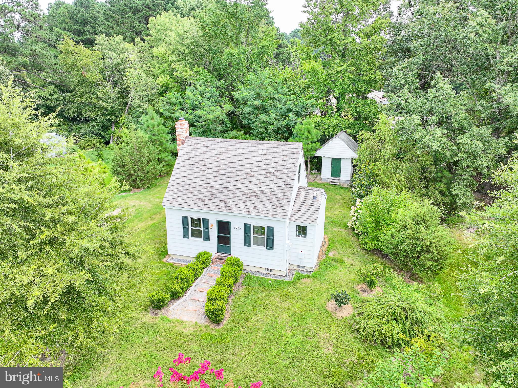 Charming Circa- 1880 Cottage in Royal Oak. Originally built around 1880 and relocated from its historic Oxford site of Wintersell Farm, this one-of-a-kind cottage is now part of a small, character- filled subdivision of unique homes. Brimming with warmth and authenticity, the house features original wood
paneling, wood floors, exposed beams, and a cozy fireplace. A galley kitchen, full bath, laundry closet, and a comfortable bedroom complete the intimate interior.
The thoughtfully landscaped lot offers privacy and year round natural beauty, with mature plantings, partial fencing and a delightful garden shed. Enjoy the peaceful setting between Easton and Saint Michaels and just minutes to the Oxford-Bellevue Ferry. The property is accessed via a shared entry road, with a road maintenance agreement in place.
A rare opportunity to own a piece of Eastern Shore history with modern day convenience.