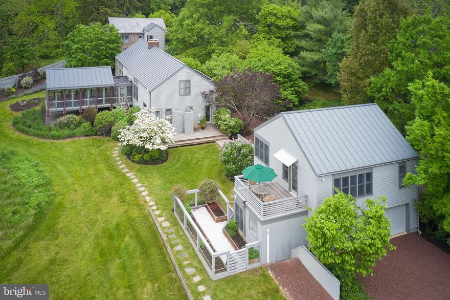 Serenity Farm is a stunning marriage between a 1700’s stone farmhouse and clean modern aesthetics. Sited on 4+ acres, this fee simple pastoral setting enables you to forget the fast pace city life to enjoy the natural verdant countryside that surrounds the home. The 100 acres of conserved land that envelops the property is the perfect buffer against future development.

     The home was ingeniously designed to place a central fireplace to act as a nucleus and a fulcrum...dividing  old and new. A spectacular stainless-steel kitchen looks out at the open dining area and the large living room beyond. The butler’s kitchen contains a washer and two dryers and a powder room. An observation room above can function as a bedroom, studio, T.V. room or office.

   The original stone section of the home contains three bedrooms and creates a step back into time. One of the more creatively designed areas of the home is the long and open screened-in porch that has a built-in grill with its own exhaust system.

    Adjacent to the home is the garage with potter’s studio and above is a complete office/guest apartment with full bath and sauna.

   The landscaping is meticulous and creates a true private oasis.

   Serenity Farm is a home for the true aficionado who cherishes the history of Bucks County and the exciting fantasy of modernism.

    Showings can begin on Saturday, May 25th. 2024.