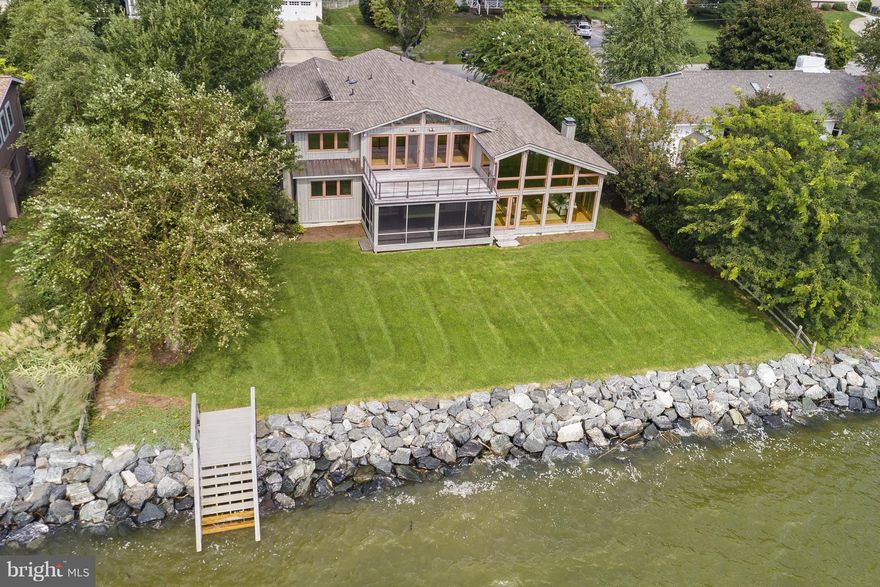 Stunning and unique contemporary home with exposed beams was completely renovated 10 years ago. One of a kind 3600 sq ft home with 100 feet of waterfront and incomparable views of the South River. Fabulous baths with procelain tile, gourmet kitchen, custom doors & lighting, red oak floors, pine and cedar walls & HVAC replaced in 2014. Waterfront screened porch, rip wrap and stairs to waterfront.