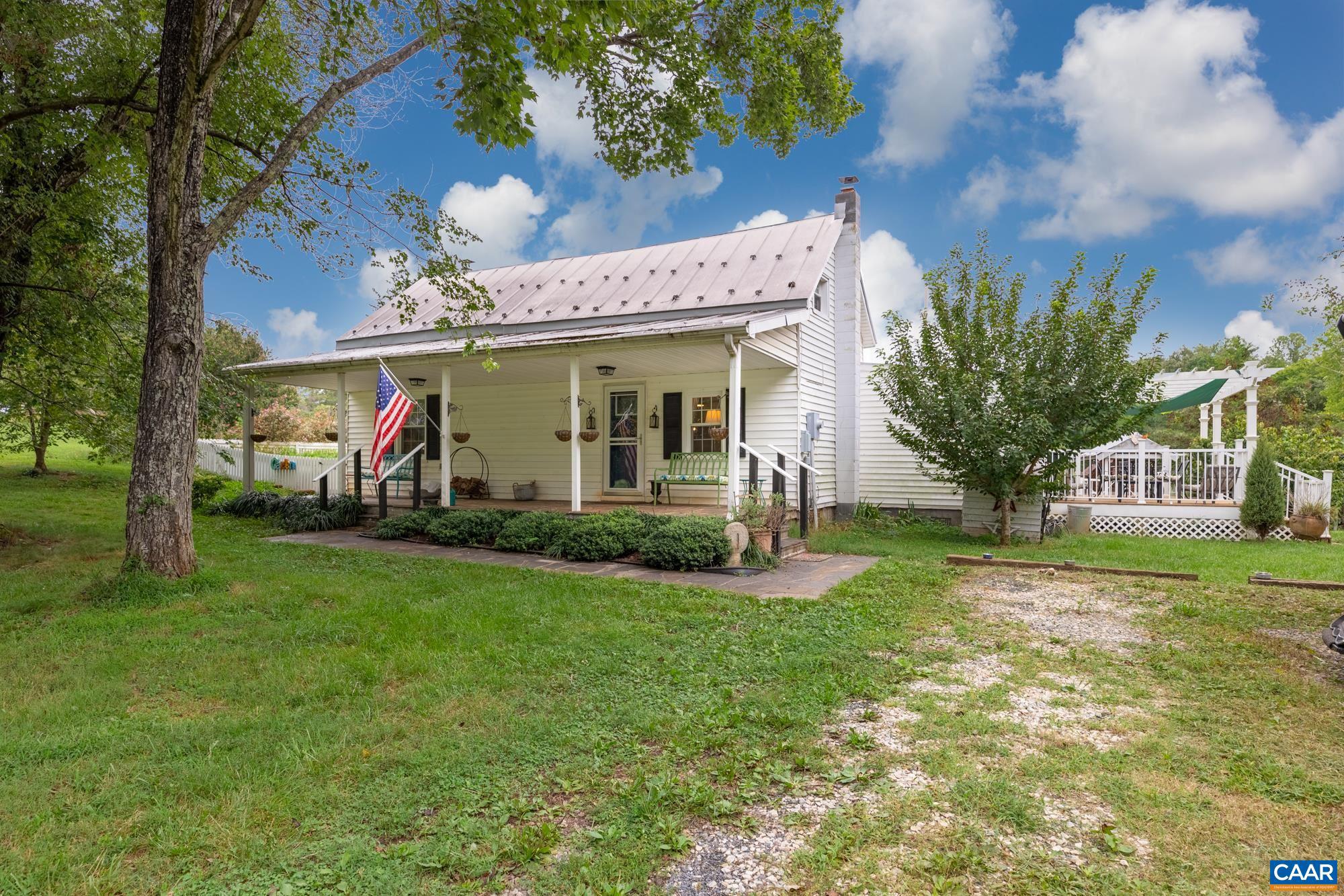 This little farm is an enchanting property, its original structure dating to 1880. Halfway between Scottsville and Dillwyn, it is a 3-bedroom, 1 bath farmhouse, 1655 square feet. Renovations and upgrades are meticulous and artistic. With mature woods and a running stream, this secluded farm has livestock infrastructure that includes a 24x24 barn and 10-ft. kick-out, pasture and paddock, sheds, smokehouse, greenhouse, woodshed, a winter/summer chicken yard, playground with playhouse, outhouse with composting toilet (for those emergency visits), outdoor screened sleeping shack, fenced garden area, herb garden, and pig yard with sheds. Fruit yard has apple, peach, Asian/pear, persimmon, grapes, currants, blue berry, fig, and sour cherry. Brand new on demand hot water heater means you'll never run out of hot water, and there is even an outdoor hot/cold running shower! Enjoy your morning coffee on the covered front porch and afternoon tea under the pergola or on the swings under the grape vines in the backyard. Off of the kitchen you find a fenced yard with a covered patio and rose bushes for bird watching. Note these pictures are 3 years old.,Wood Cabinets,Fireplace in Kitchen,Fireplace in Living Room,Fireplace in Master Bedroom