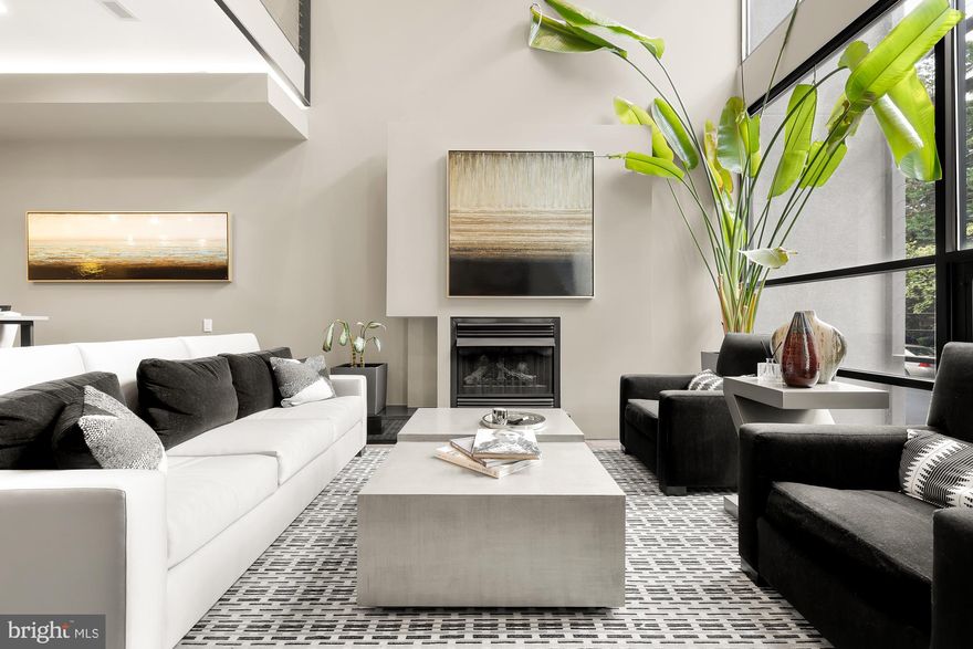 *Lowest price per square foot in the area & priced well below tax assessed value!* Breathtaking 4 level contemporary home with thoughtful renovations, captivating details, lower level unit, a *2* car garage,  a true backyard oasis, and NO hefty HOA fee. Built by Fred Bahrami and Q-14 Builders, the property offers over 3000 sqft of living space with no detail untouched in this contemporary masterpiece. Enjoy south facing floor-to-ceiling windows spanning two levels upon walking in. Open living/kitchen/dining make this an entertainer's dream. A renovated kitchen fit for a chef with sleek cabinets and counters. A large family room with built-ins and bar set up is perfect for enjoying a drink while soaking in the serene view of the outdoors. A wall displaying the finest libations actually serves as a secret door leading to the renovated powder room. Head up to find a second living area perfect for media room or a home office. A bedroom with floor to ceiling windows and renovated en-suite bath with standing shower complete the second level. The primary suite, on its own level, offers two balconies - one in the bedroom and another in the spectacular primary bath.  A luxurious primary bathroom for the magazines with dual vanities, large steam shower, and separate jetted tub with ceiling water drop. Incredible lower level offers front and rear entrance, open living area and kitchen w/ island. Renovated full bath + large bedroom round out the lower level. A true backyard oasis with deck overlooking serene outdoor pergola and garden. Two car garage includes Tesla charger.  An absolute showstopper property well worth viewing! See video tour!