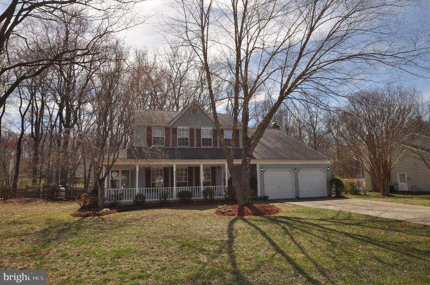 LOCATION, SPACE and LIVEABILITY - You ll Want To Live Here! Beautiful home on a quiet street features hardwood flooring throughout the main level. Kitchen features new granite counter tops and a big bay window overlooking the HUGE maintenance free deck!  Awesome home for entertaining   there s a big three season sunroom off of the family room that leads to the deck. The humongous deck has a fortified structure for heavy items   it can support the weight of a hot tub or pool   an entertainer s delight! The back yard has 2 sheds and backs to trees for privacy. The family room comes with a masonry fireplace with an energy efficient wood stove insert. There is a first-floor spacious master suite with an additional gas fireplace, as well as a large living room and formal dining room. Upstairs features a large beamed master bedroom with en suite spa bath with separate soaking tub and shower plus 3 additional good-sized bedrooms and a main hall bath. The laundry room is upstairs as well. Much of the home is freshly painted, and there is tons of storage throughout this home. A large 2 car garage completes this package. There is plenty of shopping nearby and it s convenient to Washington DC, Northern VA, National Harbor and Joint Base Andrews. Come take a look!