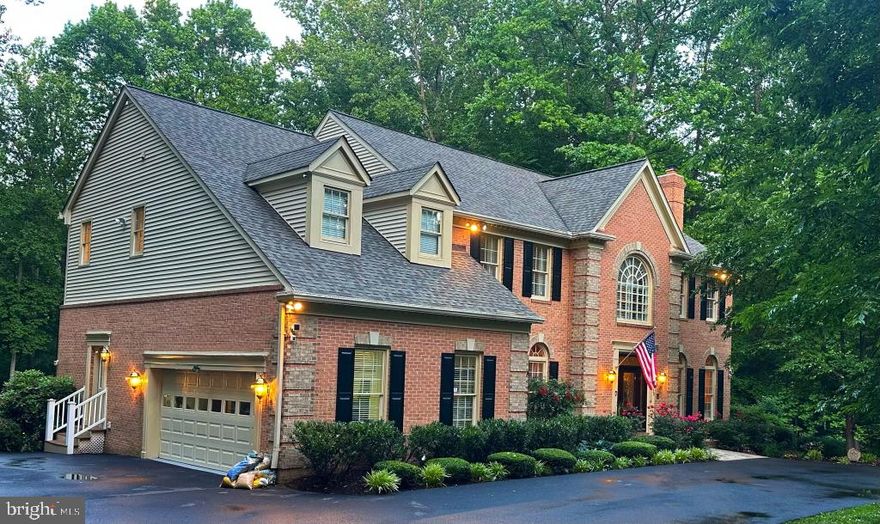 Stately 3 level brick home, turn key, close to everything, with total privacy on a gorgeous lot in the enclosed, highly sought after Devereux Manor and one of the smallest in the neighborhood. Home sits on a premium 5.01 acres with a stream and backyard suitable for a pool, entertaining 200 or your own peaceful oasis. Dramatic 10' ceilings with 2 wood burning fireplaces on the main level which was gutted down to the studs in 2012 and completely updated with hardwood floors, solid cherry cabinets, entertainment center, custom granite counter tops, gourmet kitchen and Wolf oven. Entire house renovation with geo-thermal system, new roof, septic, driveway and enclosed, two story treehouse with power and WiFi for viewing the abundant wildlife, playing cards or sleep overs. Large, finished, newly carpeted, painted and walk-out basement. Master suite 18 foot ceiling, sitting room, totally refurbished, stunning bathroom with marble, shower for two and tub. All new carpet and neutral paint throughout as well as two car, high ceiling garage with custom storage shelves. 3 of the 5 acres has an invisible dog fence. All mounted TV's and accompanying sound systems will convey and several unique pieces of furniture possible to convey also.