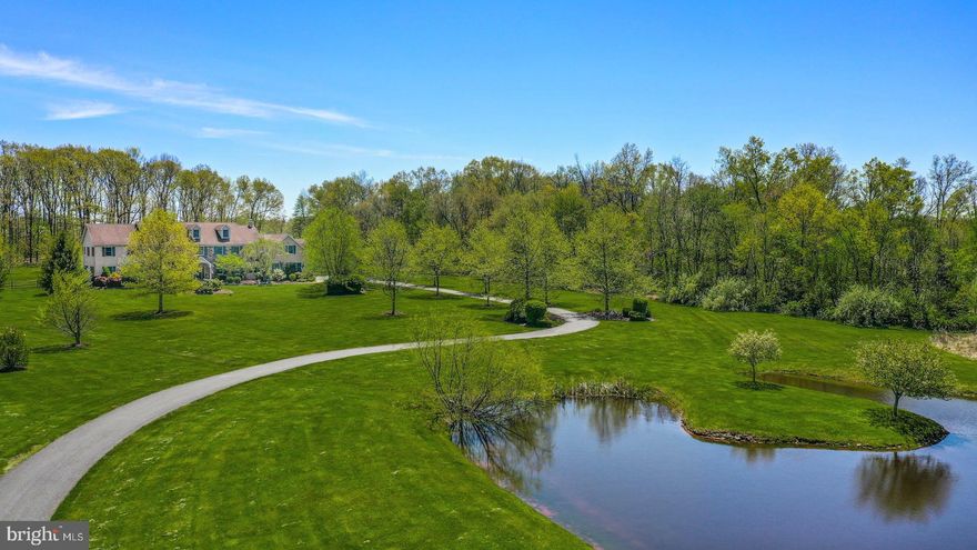 OPEN HOUSE 5/15 2-4PM! Set back on over 10 acres, Blueberry Pond combines complete privacy, wide open skies and a multitude of amenities for luxurious country living. 
 
Nearly 7,000 square feet of living space makes the interior of this home just as stunning as the land it sits on. A dramatic 2-story foyer is flanked by formal living and dining rooms. The eat-in kitchen is expansive with reclaimed heart pine floors, an island with seating, and a nearby breakfast area. The stunning great room features a vaulted open beam ceiling and wood-burning fireplace. Office space and a hobby room can also serve as a first floor bedroom for family or guests. A mud room, laundry, full and half baths complete this level. Upstairs, the primary suite is bright and airy with a gas fireplace and luxurious ensuite bath. Four more oversized bedrooms and two full baths are on this floor along with flex space currently used as a game room. 
 
Outside, a paver patio with built-in wood pergola opens to the heated in-ground pool with separate hot tub and fenced yard beyond. An orchard with fruit trees and blueberry bushes is an unexpected treat. The front yard looks out onto a serene 1-acre pond. With easy access to commuter routes as well as shopping and dining, Blueberry Pond is a welcome oasis in Upper Bucks County.