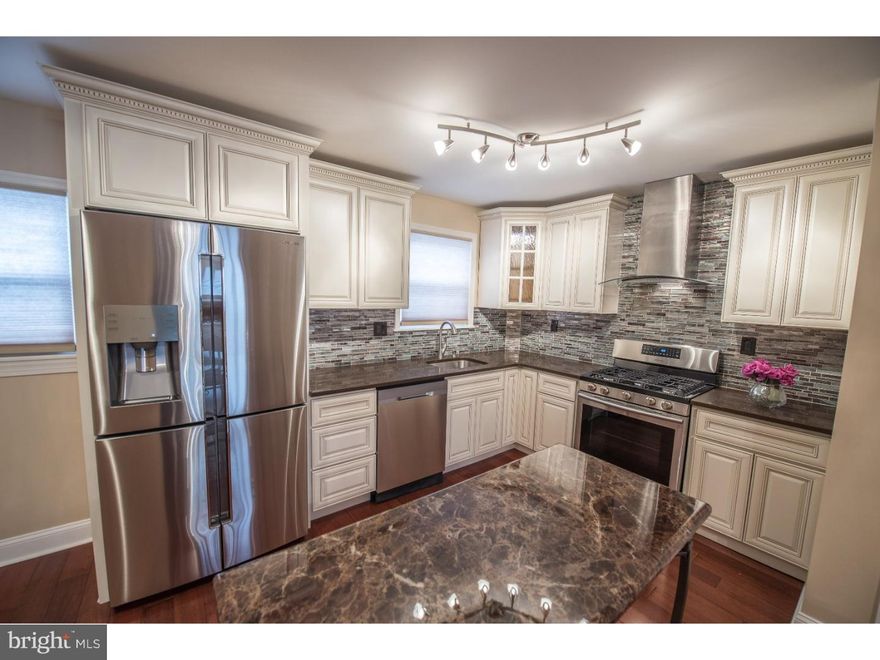 Beautiful house totally renovated with high end finishes in Parkwood.  Plenty of parking here in the cul-de-sac, also private parking in your own driveway!  This home has everything you need and more. Walk inside you will immediately notice brand new Brazilian Dark Sunset wood floor throughout the entire first level.  The diningroom has designer lighting and perfect size for a large table.  The kitchen has antique white cabinets, soft close, glass doors, gorgeous quartz countertops, high end stainless steel appliances.  Designer backsplash and stainless steel range hood makes this kitchen showroom ready! There is also a half bath on this level at the top of the basement stairs.  The upper level boasts a master bedroom suite, with Full Master Bath! You also have the hall bath for the other two bedrooms.  The lower level has a finished room large enough for a man-space, or family room.  There is another brand bedroom with a private entrance to the back. The laundry and utilities are in their seperate room with another door to the back.  All new heat, central air, new windows, designer paint, this house is ready for you to move right in!