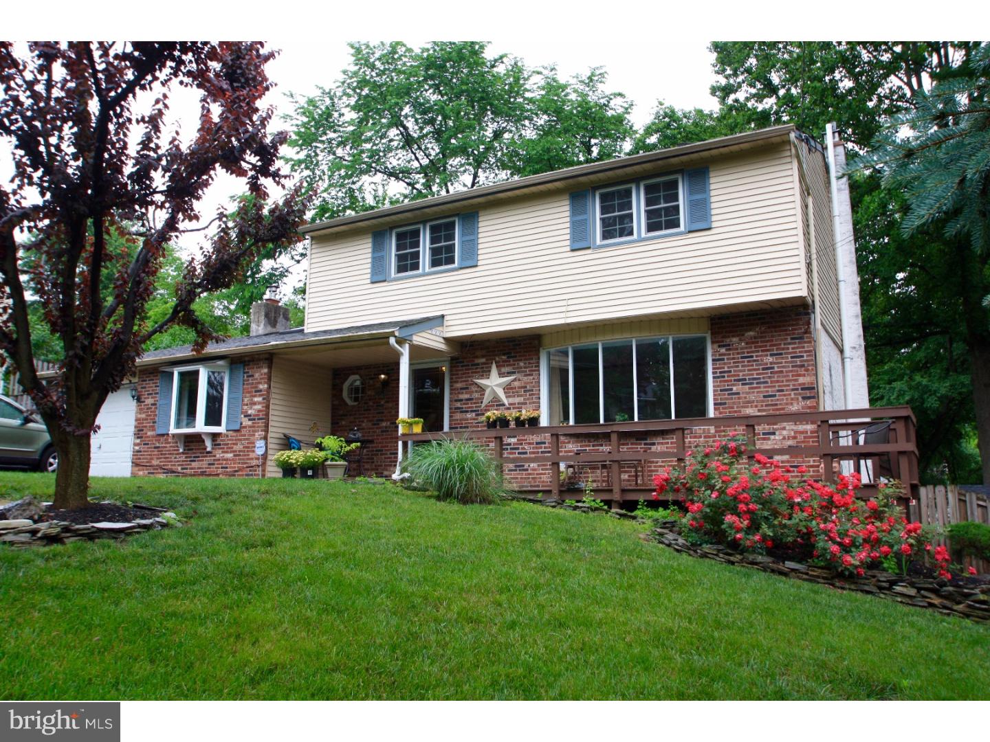 This inviting home is perfect for enjoying summer with a beautifully landscaped and tranquil yard with an extensive deck for outdoor entertaining. With improvements throughout, this 4 bedroom home offers the space and upgrades to meet your needs. A welcoming front porch invites you in to the home where the foyer leads to bright living and dining rooms with hardwood flooring. A kitchen remodel features newer cabinetry, high end appliances, and granite countertops. Enjoy your morning coffee from your eat-in kitchen which opens to the expansive deck and yard. A cathedral ceiling and skylight make the great room bright and airy while the brick fireplace offers a cozy spot for cool evenings. Upstairs offers 4 spacious bedrooms with hardwood flooring and an remodeled full bath. The walk out basement with new flooring and full bath provides additional living and storage space. Upgrades also include new windows, lighting, designer fan, and built in shelving. The home is freshly painted and ready for you to move in.