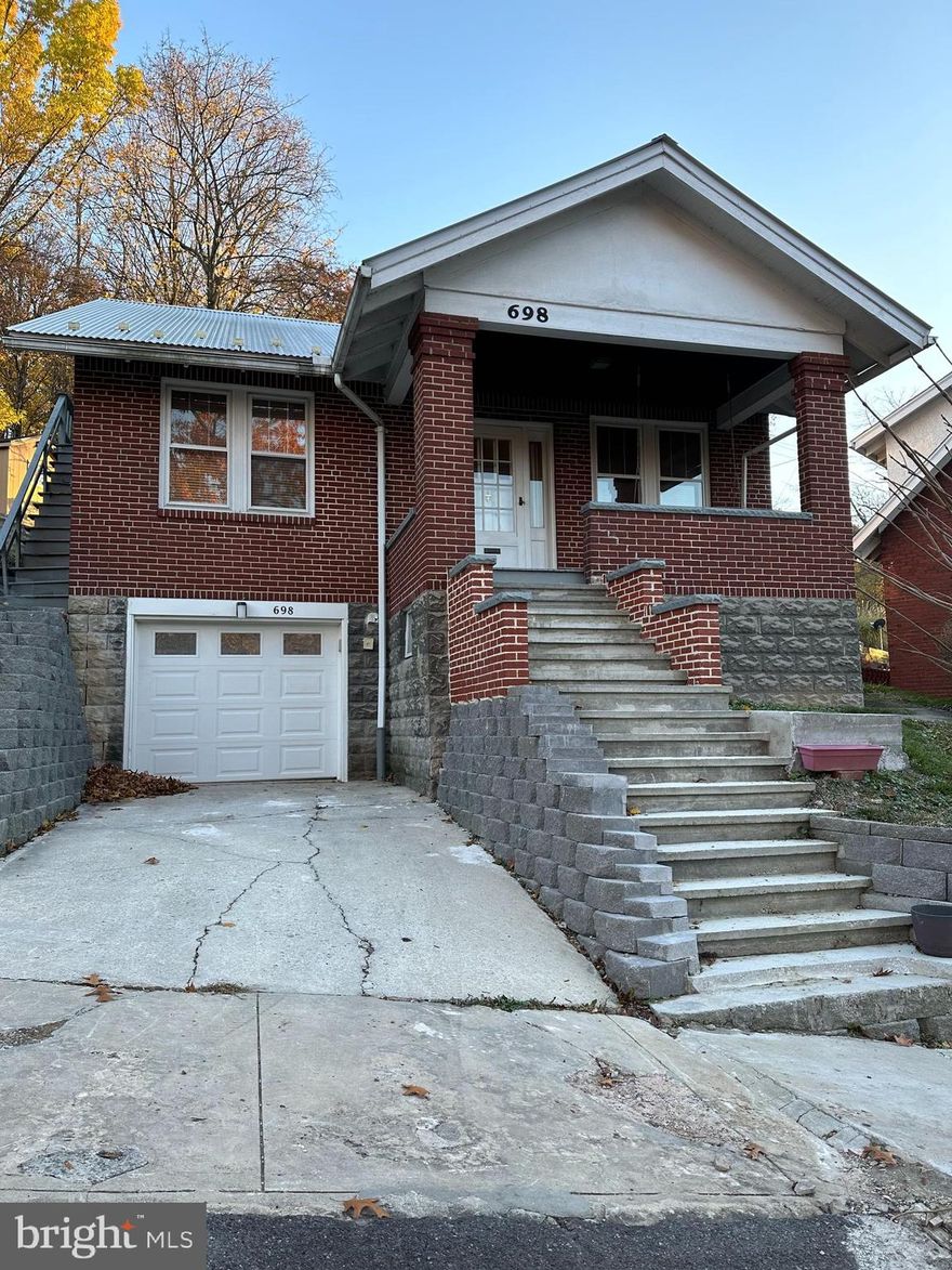 This beautiful brick home is the perfect place to settle into after a long day.  It is nestled inside the city of Cumberland and has a front porch on which to sit and relax.  The garage leads into the basement which then has stairs up to the main floor.   The upper floor is currently used for storage but can become two usable rooms if more space is needed.  One room could be a third bedroom and the other room is a nice bonus room. The main floor entrance leads in to the living room where there are beautiful wood framed windows in which to enjoy the view.  The living room leads into the dining area that is large enough to host a gathering of friends and family.  The unique kitchen has a rear access to the back yard and separate seating area for eating.  Stop in and take a look for yourself.  This could be your new home.