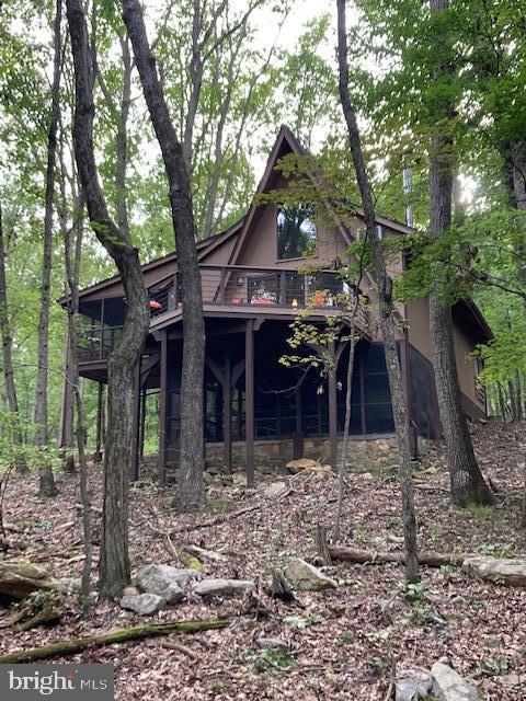 Looking for the perfect getaway from the hustle and bustle of the city? This A-frame style chalet is nestled in the trees of Coolfont Mountainside, just minutes from historic Berkeley Springs. Features 3 BR, 3.5 baths, open floor plan with spacious great room, wood burning stove , main level master bedroom, and a screened in porch. Upstairs is a cozy loft bedroom. The finished lower level has large family room, bedroom, full bath and a screened in patio. Enjoy the community pool and tennis courts. Won't last long!