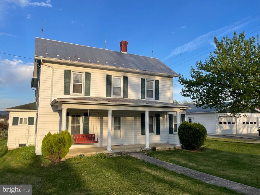 Old country home with original oak paneling on .48 acre, 2 garages, 2 outbuildings, city water, central heat/air, generac generator