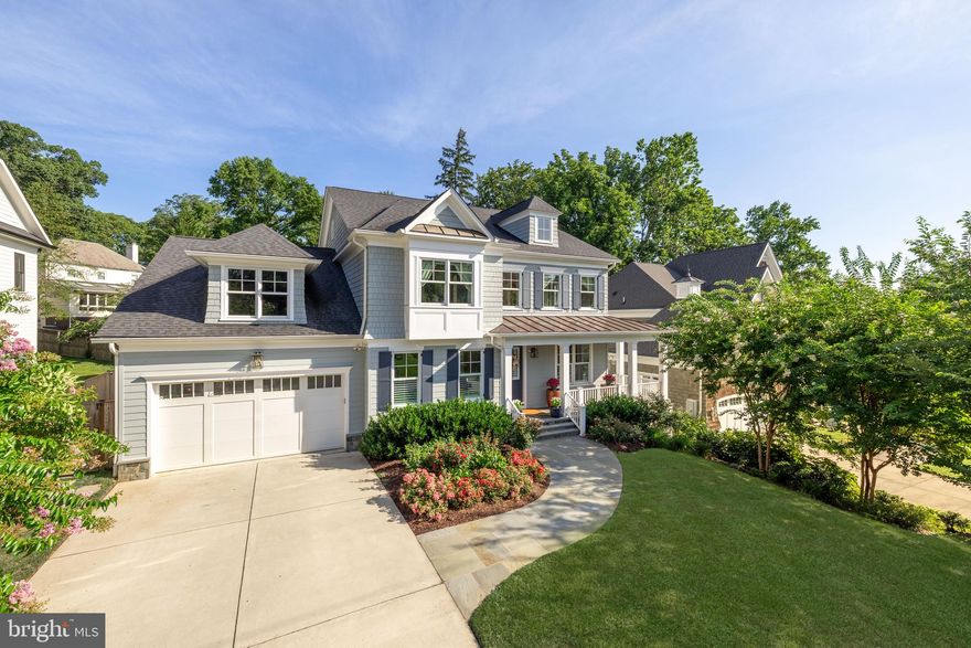 With wide streets and deep front lawns, Bradley Woods evokes the sensation of a spacious suburban neighborhood while remaining mere minutes to the heart of urban, downtown Bethesda. Prominently perched on 0.26 acres in the heart of this wooded enclave is 5907 Aberdeen Road, an immaculate modern craftsman constructed in 2019 by Chase Builders. Approached by a long driveway traversing a manicured front lawn, the home’s cedar and Hardie Plank siding exterior creates an inviting initial impression, a sensation augmented by the cozy wraparound covered porch and sweeping flagstone walkway. In a nod to tradition, the main level is arranged in a classic center hall layout, with formal living and dining rooms flanking the entryway. Oak flooring, custom millwork, tray ceilings, Visual Comfort lighting, Legrand panels, Emtek hardware, and Jeld-Wen windows all represent top-of-the-line fixtures and finishes as a testament to the quality of construction. An intimate library is tucked away, featuring built-ins, a large window, and the ability to be closed off via double French doors. The rear portion of the main level, spanning the home’s entire width, is dedicated to informal areas. The large family room is capped by a dramatic cedar beam ceiling, framing a roaring fireplace with Taj Mahal quartzite surround. A true open concept layout carries through to the chef’s kitchen, as visually stunning as it is functional. The accent piece is a custom range hood framed with a brushed gold border, a beautiful contrast to the surrounding full-height marble slab backsplash. Furniture-grade inset Brookhaven cabinetry meets thick Caesarstone concrete countertops to create a neutral backdrop for the soft brass hardware, and to conceal a comprehensive suite of top-end Thermador appliances. A true butler’s panty connects directly to the dining room and branches off to a large, exquisitely thought-out mudroom area leading to the attached two-car garage. A spectacular and seamless addition by Marvel Homes and Division 12 Design Studio created a large private office with direct rear patio access. Honing in on the home’s coastal flair, the space features a rich tongue and groove ceiling as well as vertical shiplap paneling and custom built-ins. The grand staircase to the upper level is flooded with natural light from a large wall of glass in the landing. Immediately adjacent is the entrance to the primary suite, a substantial space augmented by a soaring vaulted ceiling in the main sleeping room. A vestibule leads to two large walk-in closets, outfitted with custom shelving, as well as the spa-like primary bath. Clad in sumptuous Noble Carrara Zebrino marble, ubiquitous amenities comprise dual vanities, separate water closet, walk-in shower, and freestanding soaking tub set against a large picture window. Secondary bedrooms all feature walk-in closets, with one ensuite and the remaining two sharing an ample Jack-and-Jill. A convenient laundry room completes the upper level. Filled with natural light, the lower level’s Coretec Pro flooring establishes a warm ambiance. A large recreation room and game room anchor one end of the space, while the padded fitness center and fifth bedroom suite anchor the other. A fully-equipped wet bar clad in Statuario marble as well as a unique soundproofed music studio serve as the transition. Technologically advanced mechanical systems include energy-efficient HVAC, comprehensive security, a whole-home Generac generator, fire suppression capabilities, and elevator-readiness for turnkey living. Fully fenced, level, and private, the rear lawn is a blend of hardscaping via the newly-installed flagstone patio, and an extensive landscaping package with vibrant flora. 5907 Aberdeen Road blends top-shelf quality and design with an extensive list of desirable amenities and an unparalleled location to create a home for the most discerning buyer.