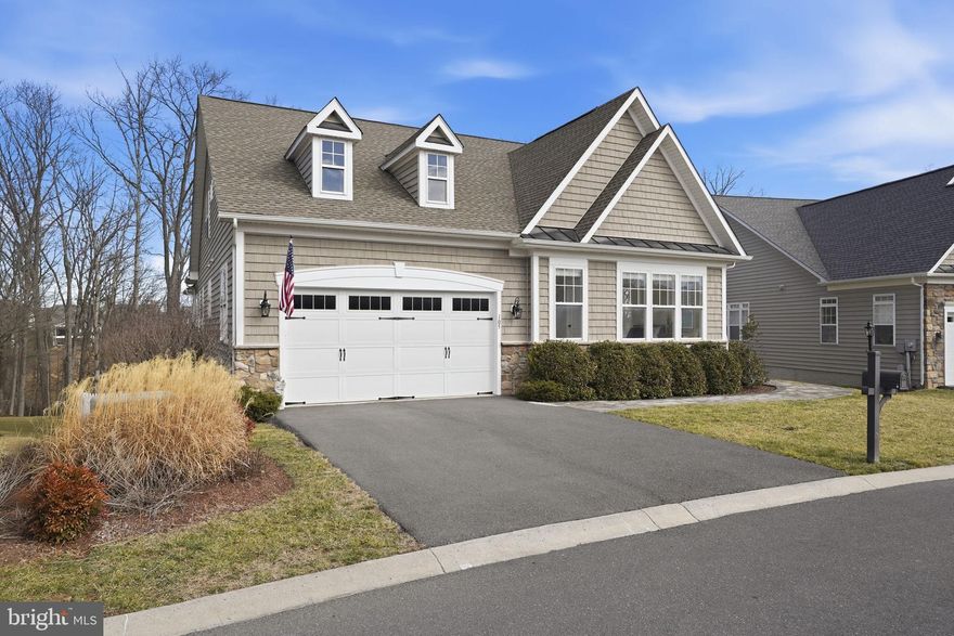 Welcome home to Lake Frederick's 55+ community with this gorgeous home nestled on the clubhouse side of the lake with a secluded, tree-lined homesite featuring tranquil views and privacy. This extensively renovated and stunning 5,200+ square foot residence spans three fully finished levels and showcases abundant natural light, refined living spaces, and a seamless blend of elegance and everyday comfort.
<br><br>
A beautifully crafted paver walkway welcomes you to the front entrance and into a striking main level defined by soaring ceilings and an open, airy design. The expansive great room is anchored by a warm gas fireplace and transitions effortlessly into the dining area and a completely renovated gourmet kitchen (2022) featuring, granite counters, stainless steel appliances, and well-planned cabinetry. Just beyond, the breakfast room offers a comfortable spot for everyday meals and opens directly onto the spacious Trex deck - an ideal setting for entertaining or unwinding while enjoying views of the fenced backyard, mature trees, and the lake beyond.<br><br>
The main level includes two private ensuite bedrooms, highlighted by a spacious and luxurious primary suite. The primary bath was thoughtfully renovated in 2024 and delivers a true spa experience, complete with a corner soaking tub and a separate walk-in shower. Oversized closets are found throughout the home, enhanced by custom Econize closet systems (2025) and a beautifully designed pantry that blend function with refined organization. A secluded office, positioned behind glass French doors, offers an ideal work-from-home retreat and opens into the enclosed sunroom, with direct access to the rear deck.<br><br>
Upstairs, a versatile loft area with built-ins overlooks the main living space and is ideal as a secondary lounge or reading area. This level also includes a third bedroom with its own full ensuite bath and walk-in closet, offering privacy and comfort for guests or family members.
<br><br>
The walkout lower level expands the living space significantly and is designed for both recreation and relaxation. It includes a large recreation room, a separate lounge area with a bar, plenty of room for a home gym as well as the fourth bedroom and a gorgeous fourth full bathroom complete with a sauna that is negotiable if you'd like to include that with the purchase of this beautiful home. There is also a substantial unfinished storage area, ensuring plenty of room for seasonal items and long-term storage. The lower level opens directly to the fenced backyard and covered outdoor patio, complete with ceiling fan and lighting for year-round enjoyment.
<br><br>
Additional highlights include a whole-house water filter, newer roof (2017), newer HVAC (2024), and newer hot water heater (2025), renovated kitchen (2022), remodeled primary bath (2024), and custom closets (2025) offering peace of mind for years to come. The two-car garage features boat/kayak lift storage, complementing the home’s serene lake-adjacent setting.  With its spacious layout, abundant natural light, and exceptionally private setting, this home truly offers a rare combination of space, comfort, and lifestyle.
<br><br>
As a resident of Trilogy at Lake Frederick, you'll enjoy a wealth of incredible amenities designed to enhance your lifestyle. Dive into relaxation with both indoor and outdoor pools, stay active in the state-of-the-art fitness center, and unwind at the well-equipped community clubhouse. Savor gourmet meals at the farm-to-table restaurant and socialize in the exclusive members-only lounge. For the sports enthusiasts, tennis and pickleball courts, as well as a dog park, offer ample opportunities for recreation, while extensive lake trails beckon for serene strolls and outdoor adventures. Join a vibrant community of welcoming neighbors and future friends. Experience the pinnacle of resort living at Trilogy at Lake Frederick—where your dream home and ideal lifestyle come together seamlessly.