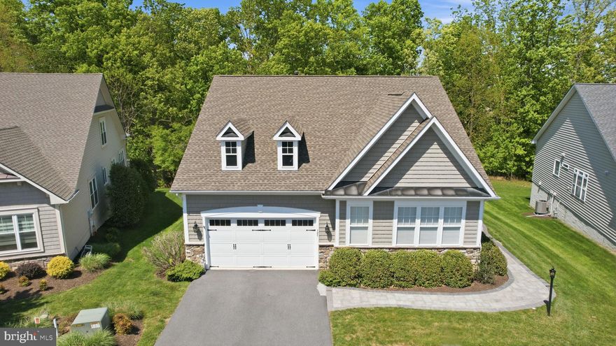 Welcome home to Lake Frederick's 55+ community with this gorgeous home nestled on the clubhouse side of the lake with a secluded, tree-lined homesite featuring tranquil views and privacy. This extensively renovated and stunning 5,200+ square foot residence spans three fully finished levels and showcases abundant natural light, refined living spaces, and a seamless blend of elegance and everyday comfort.
<br><br>
A beautifully crafted paver walkway welcomes you to the front entrance and into a striking main level defined by soaring ceilings and an open, airy design. The expansive great room is anchored by a warm gas fireplace and transitions effortlessly into the dining area and a completely renovated gourmet kitchen (2022) featuring, granite counters, stainless steel appliances, and well-planned cabinetry. Just beyond, the breakfast room offers a comfortable spot for everyday meals and opens directly onto the spacious Trex deck - an ideal setting for entertaining or unwinding while enjoying views of the fenced backyard, mature trees, and the lake beyond.<br><br>
The main level includes two private ensuite bedrooms, highlighted by a spacious and luxurious primary suite. The primary bath was thoughtfully renovated in 2024 and delivers a true spa experience, complete with a corner soaking tub and a separate walk-in shower. Oversized closets are found throughout the home, enhanced by custom Econize closet systems (2025) and a beautifully designed pantry that blend function with refined organization. A secluded office, positioned behind glass French doors, offers an ideal work-from-home retreat and opens into the enclosed sunroom, with direct access to the rear deck.<br><br>
Upstairs, a versatile loft area with built-ins overlooks the main living space and is ideal as a secondary lounge or reading area. This level also includes a third bedroom with its own full ensuite bath and walk-in closet, offering privacy and comfort for guests or family members.
<br><br>
The walkout lower level expands the living space significantly and is designed for both recreation and relaxation. It includes a large recreation room, a separate lounge area with a bar, plenty of room for a home gym as well as the fourth bedroom and a gorgeous fourth full bathroom complete with a sauna that is negotiable if you'd like to include that with the purchase of this beautiful home. There is also a substantial unfinished storage area, ensuring plenty of room for seasonal items and long-term storage. The lower level opens directly to the fenced backyard and covered outdoor patio, complete with ceiling fan and lighting for year-round enjoyment.
<br><br>
Additional highlights include a whole-house water filter, newer roof (2017), newer HVAC (2024), and newer hot water heater (2025), renovated kitchen (2022), remodeled primary bath (2024), and custom closets (2025) offering peace of mind for years to come. The two-car garage features boat/kayak lift storage, complementing the home’s serene lake-adjacent setting.  With its spacious layout, abundant natural light, and exceptionally private setting, this home truly offers a rare combination of space, comfort, and lifestyle.
<br><br>
As a resident of Trilogy at Lake Frederick, you'll enjoy a wealth of incredible amenities designed to enhance your lifestyle. Dive into relaxation with both indoor and outdoor pools, stay active in the state-of-the-art fitness center, and unwind at the well-equipped community clubhouse. Savor gourmet meals at the farm-to-table restaurant and socialize in the exclusive members-only lounge. For the sports enthusiasts, tennis and pickleball courts, as well as a dog park, offer ample opportunities for recreation, while extensive lake trails beckon for serene strolls and outdoor adventures. Join a vibrant community of welcoming neighbors and future friends. Experience the pinnacle of resort living at Trilogy at Lake Frederick—where your dream home and ideal lifestyle come together seamlessly.