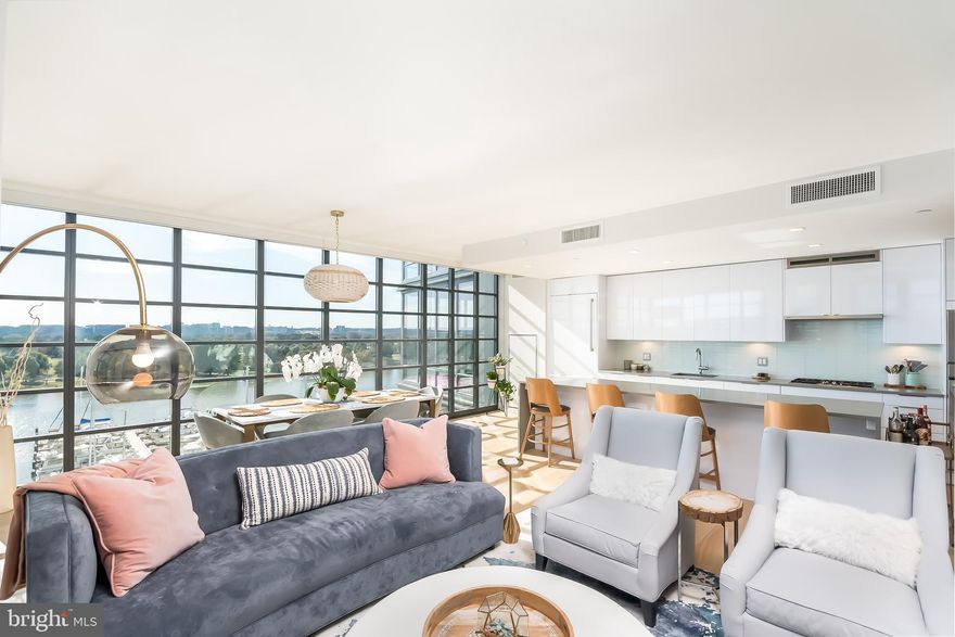 Amazing opportunity to own one of the most desirable panoramic water views in DC overlooking the thriving District Wharf and Marina from 7th stories up. Entertain across almost 2,200 sf inside and out in style as you step onto your living room or master bedroom balcony with a view for miles down the Potomac River and across to the shore-lined Cherry trees unlike any other condo view in DC. Natural light abounds with floor-to-ceiling windows throughout this 3BR 2.5BA "09" tier unit at VIO. Modern luxury at every turn: white oak hardwoods, marble baths, quartz counters & Porcelanosa cabinetry. Private elevator lobby with elevator opening directly to your unit. 2 garage parking spaces + conditioned Storage Unit included. Pool, fitness & 24-hr Concierge on-site and low condo fee.  By Appointment, see Virtual Tour Link.