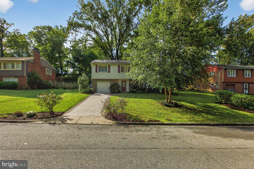 Welcome to 7507 Essex Avenue — a well-maintained and thoughtfully updated home in a prime Springfield location, just one block from trails leading to Accotink Park and Brookfield Park. This charming residence features a classic brick lower level with wood siding, a durable metal roof, and a one-car garage with automatic opener.

The welcoming wide entry foyer offers ceramic tile flooring, recessed lighting, and a convenient coat closet. The lower-level family room is warm and inviting with updated carpet, recessed lighting, a bay window, built-in shelving, and an electric fireplace with wood mantle and brick hearth. A nearby wet bar with granite countertops, undermount stainless-steel sink, and abundant cabinetry makes this level ideal for entertaining or second living space. The lower-level full bath includes a ceramic tile floor, tiled tub surround, and vanity with granite top. The utility room features a stackable front-load LG washer and dryer, gas HVAC system, utility sink, and a tankless gas water heater installed in 2023.

Upstairs, the light-filled living room showcases cherry wood floors, crown molding, ceiling fan, a large picture window, and a cozy wood-burning fireplace with brick surround and wood mantle. The dining area offers crown molding and chair rail and flows seamlessly into the updated open kitchen with granite countertops, ceramic tile flooring, stainless-steel appliances, recessed lighting, and access to the backyard.

Step outside to a relaxing and private brick paver patio—perfect for grilling and unwinding—overlooking a large fenced yard with mature trees. The upper level features cherry wood flooring throughout, a renovated hall bath with ceramic tile, double vanity with granite tops, updated lighting, and brushed-nickel fixtures. The primary bedroom includes a spacious closet, while the second bedroom offers a closet with built-in organizers, plus a third bedroom.

Enjoy an exceptional location with easy access to downtown Springfield, I-95, I-495, the Springfield Metro and VRE stations, shopping, dining, and commuter routes.