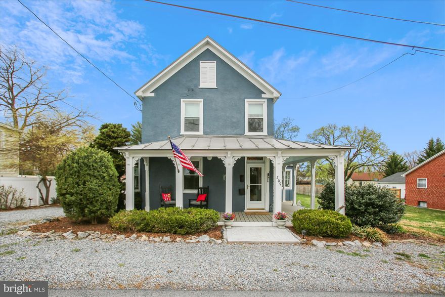 Charming and character filled, this delightful 1917 home has been thoughtfully and fully renovated, blending timeless appeal and vintage character with modern comforts.  Nestled on a spacious 1/3-acre lot, the property boasts beautifully restored features both indoors and outdoors, ideal for everyday living and entertainment.  One can’t help admire the over 1800 square feet on 2 finished levels complete with a separate outbuilding (use as an office, studio, guest cottage, entertainment space, exercise/yoga studio, etc.) w/a screen porch as well as a separate storage shed adding both functionality and character to the partially fenced rear yard. With 2 bedrooms, 1 full bathroom, and 1 half bathroom, this home’s fully renovated custom features are fabulous!  Marvelous main level features include a wraparound front porch with Victorian corbels.  Stained glass address window above front door. The welcoming foyer with Ceilume ceiling tiles, vintage-inspired lighting, crown molding, & refinished hardwood floors is the perfect entry.  Refinished hardwood floors, Ceilume ceiling tiles, and crown molding continue to the lovely living room with bay window, custom window blinds,  and custom paint.  Refinished hardwood floors, Ceilume ceiling tiles, & crown molding continue to the dining room with built-in China cabinet, built-in shelving, and propane gas fireplace. The breakfast bar from dining room opens to the fully renovated kitchen complete with custom cabinetry, propane gas cooking, farm sink, vintage inspired lighting, solid surface counter, custom tile backsplash, & center island for additional prep space.  Wood floors and custom paint continue to the mudroom with French door to side porch, cork-board message center, vintage inspired lighting, and built-in storage. The half bath offers tile floor, pedestal sink, and custom paint.  Step down from the kitchen to the spectacular sunroom with LVP floors, ceiling fan, recessed lights, custom paint, ductless split system with auto temp control feature,  and French doors to rear yard.  The Lovely upper-level features…Hardwoods stairs with “library inspired” treads continue to the upper-level hallway.  The primary bedroom with new carpeting, custom paint, crown and chair molding, Ceilume tile ceiling, wall sconces, walk-in closet, and vintage-inspired lighting is a tranquil retreat.  The light and bright laundry room with washer & dryer, shelving, built-in storage, and clothes drying bar is conveniently located.  The spacious full bath with vintage-inspired ceramic tile floor, crown and chair molding, beadboard paneling, Ceilume tile ceiling, custom paint, separate shower with custom tile, restored claw-foot tub, single-sink vanity with quartzite counter, and wall sconces is the perfect blend of vintage charm combined with modern touches.  The 2nd bedroom offers wood floors, vintage-inspired lighting, recessed lights, and wonderful  natural light.  Extraordinary exterior features include...a 1/3-acre lot with SPECTACULAR outbuilding with screen porch (with electric)…includes an old feeding trough that's been converted to a cooler ...and large storage closet.   There's an additional garden shed for storage, too. The home is perfectly situated in close proximity to the historic town of Berryville as well as to commuter routes Rt. 7, Rt. 340, and I81. The quaint town nestled in the picturesque Shenandoah Valley is the largest town in Clarke County and features a charming downtown area with many of the buildings dating back to the Civil War era.  Enjoy many independent businesses including shops and restaurants. Award winning wineries, festivals, and events…farm to table restaurants…and entertainment including the Barns of Rose Hill which is a performing arts venue and community center.  You’ll never lack for something fun to do! Air BnB potential (buyer due diligence with Town of Berryville), primary residence, or weekend getaway awaits! There truly is no place like home:-)