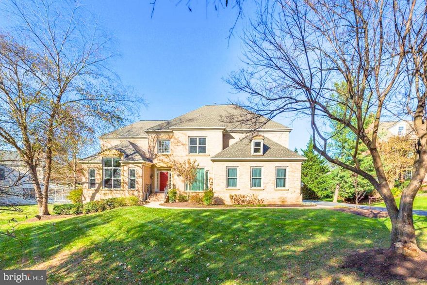 **Private showing will start on Jan 19** Magnificent residence on a beautifully treed, professionally landscaped lot in highly sought-after McLean 100. This exceptional home features soaring ceilings and a dramatic open floor plan with walls of windows that flood every room with natural light.
Elegant architectural details include coffered and tray ceilings, gleaming hardwood floors on two levels, handsome moldings and wainscoting, and a grand foyer.
The main level offers expansive living and entertaining spaces: a stunning two-story great room, large library with custom built-ins, and hearth room with built-ins and two-sided fireplace off the kitchen. The custom kitchen with grey and white cabinetry opens seamlessly to the family room—ideal for both everyday living and entertaining.
This 6-bedroom, 5.5-bath home includes a desirable main-level primary suite with spa-inspired bath and steam shower. The upper level features four spacious bedrooms and three fully renovated bathrooms.
The huge walk-out lower level is fully finished and sun-filled, with luxury vinyl plank flooring, an additional bedroom and full bath, and expansive flexible space perfect for a recreation room, gym, or guest suite.
Exceptional outdoor living includes a large screened porch and Trex deck overlooking a flat, private backyard with fountain—an ideal setting for relaxing or entertaining.