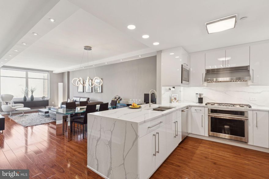 Enjoy breathtaking Center City skyline views from this masterfully designed and exceptionally upgraded residence in the sky. An impressive foyer welcomes you into an expansive living and dining area, featuring gleaming wide-plank hardwood floors and oversized windows that flood the space with natural light. Your private covered balcony is accessed off the living area and perfect for entertaining, unwinding or enjoying your morning coffee. The lavish gourmet chef’s kitchen boasts stainless steel appliances, rich granite countertops, gas cooking, and a convenient breakfast bar. The bedroom is generously proportioned and offers an expansive walk-in closet with custom built-ins. The spa-like bathroom features a frameless glass-enclosed shower, designer finishes, and ample storage. A coveted garage parking space, an on-site storage unit, and a host of discerning upgrades complete this one-of-a-kind pet friendly residence.  Perfectly situated on the Avenue of the Arts, Symphony House is a premier luxury building offering a 24-hour concierge and door attendant, a heated lap pool with a hot tub, a state-of-the-art fitness center, an outdoor residents’ terrace, an elegant library, a residents’ lounge, a wine cellar and tasting room, private dining salons, and more. Live in the heart of Philadelphia’s finest attractions, with The Kimmel Center, the Academy of Music, theaters, fine dining, world-class shopping, renowned cultural destinations, and vibrant nightlife just steps away.