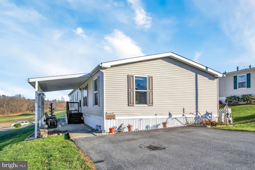 Affordable, comfortable and spacious home ownership is found in this 2005 double-wide, located in the beautiful 55+ Community of Crestview Acres MHP.  Country quiet, yet minutes to I83, Rt30, East York, Red Lion and all the conveniences you could possibly want or need! Awesome park location with views from the interior and the 11x 12 covered deck found off the back of the home. A large covered side patio offers a protected entry and patio area, for additional extended living space. Step inside to vaulted ceilings. crown moldings and spacious rooms...living room, HUGE kitchen, dining room, 4-seasons room, laundry room, primary bedroom, primary bath, and several walk-in closets. A slider in the 4-seasons room allows you easy access to the covered deck. The laundry room also has deck access. The primary bathroom features double bowl vanity and a large walk-in shower. Newer water heater. There are two parking spaces in the front of the property.  Convenient and secure 12x16 storage shed is found in the rear of the property, with paved area. Community offers walking trails, putting green and gazebo area. Park approval is required.  AGENTS - Please read Agent Remarks!