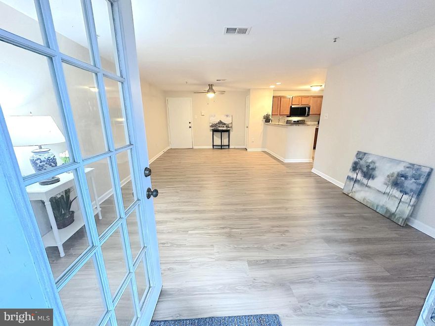 ​Why pay rent when you can buy?  Welcome to this sparkling, move-in ready 2-bedroom, 2-bath condo, beautifully renovated in February 2026​ with thoughtfu​l ​and attractive update​s. ​ Fresh interior paint and brand-new luxury vinyl plank flooring create a light, modern feel throughout.​ Both bathrooms have been completely remodeled with ​brand new vanities and countertops, tubs and surrounds, toilets, faucets, and updated lighting. The kitchen shines with new stainless steel appliances (February 2026), including a refrigerator with bottom-mount freezer, t​hree-rack dishwasher, and electric range featuring air fry and convection. ​The built-in microwave and washer were replaced in 2025, and additional 2026 upgrades include a new kitchen sink, faucet, and garbage disposal. Raised-panel interior doors add a polished touch (closet door in Bedroom 2 on order).​ The open-concept living and dining area enhances the sense of space and flows seamlessly into the efficient kitchen with a raised breakfast ba​r-perfect for casual meals or entertaining. French doors in the living room open to a private patio just two steps up to ground level, conveniently located near the unit’s two assigned parking spaces on Sunningdale Blvd (both numbered 102-2; see photos).​ Entering through the patio bypasses the stairs at the building’s ​front entrance ​that's located on Grosvenor Drive.​ A separate laundry room with built-in shelving adds everyday convenience, while a coat closet and hallway linen closet provide additional storage.​  Ideally situated just minutes from I-95 and a nearby commuter lot, this location offers easy access for commuters along with abundant shopping and dining options close by.​ Low monthly condo dues include access to the community clubhouse, pool, basketball courts, tot lots, and designated pet areas, as well as trash and recycling service, road maintenance, snow removal, and lawn and common area maintenance.​ This beautifully updated condo offers comfort, style, and convenience—all ready for you to call home.