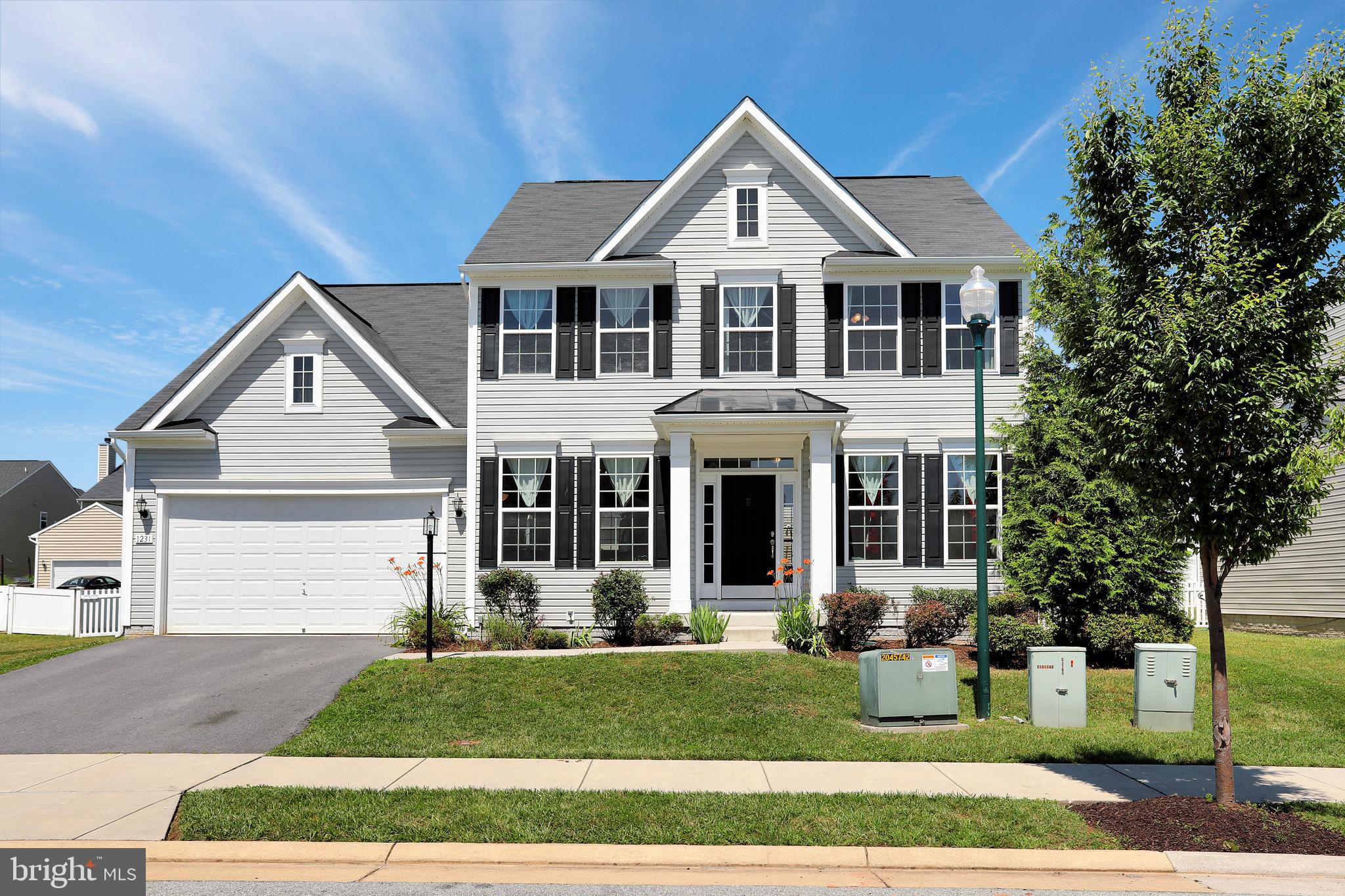 COLONIAL IN FAIRFAX CROSSING! Four Spacious Bedrooms, with Two and a half Bathrooms, Formal Living & Dining Rooms, Large Family Room Open to the Kitchen, and Large Butlers Pantry with Lots of Cabinet Space! Full Basement that features a walkout to the Rear Yard! Large flat rear yard that is completely fenced. Located in a Very Convenient and Commuter Friendly Location!Community has sidewalks throughout, with quick drive to Restaurants, Shopping, and Medical!