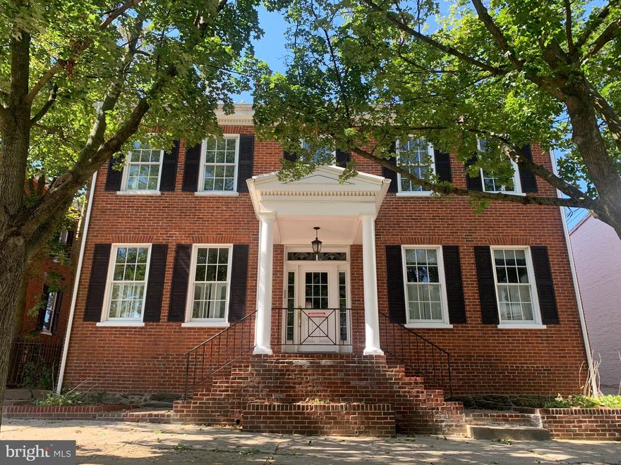 Welcome to 162 E. Main Street!  This stately two-story brick residence in the City of Westminster exudes timeless elegance and architectural character. Offering five bedrooms, the home is graced with rich hardwood floors and distinguished details throughout. Beautiful stained glass transom windows adorn both the front and rear entrances, adding an element of historic charm. A front and rear staircase provide an air of sophistication as well as convenience, while the expansive kitchen offers exceptional space for culinary pursuits and gatherings. At the rear of the property, five private parking spaces enhance the practicality of this distinguished home.  Enjoy the convenience of being in historic downtown Westminster for dining, shopping, festivals and holiday events and just minutes away from the  Carroll County Farm Museum and Carroll County Ag Center hosting many yearly events, the Life Bridge Hospital and McDaniel College for college football and artistic events  Ideally located within Westminster, this residence presents a rare opportunity to enjoy gracious living in a setting of enduring style. Square footage on tax record is incorrect, estimated is 2704 square feet.