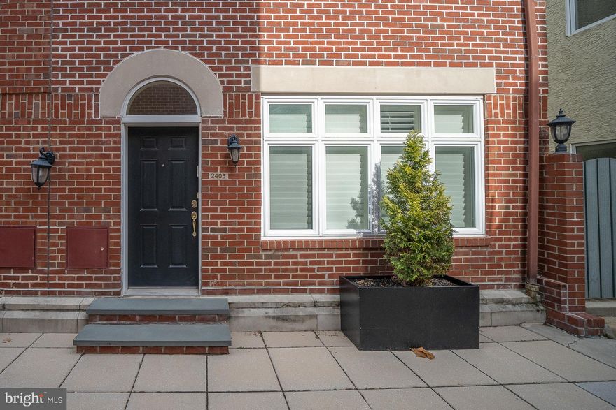 Don’t miss this fabulous Gated Fitler Walk Townhome!  Featuring an open floorplan, 3 bedrooms, 2 and a half baths, a deeded garage parking space and a fabulous location, this home has it all!  As you enter from the private walk, you will immediately notice the beautiful hardwood floors that flow throughout the first floor.  The living room has a gas fireplace and a wall of custom built-ins is flooded with sunlight and welcomes into the home.  Step up to the open kitchen and dining area with sliders to the back patio perfect dining both inside or al fresco.  The spacious kitchen with a built-in refrigerator, gas cooking, subway tile backsplash, and granite counters offers tons of storage and counter space including a peninsula for serving your next holiday spread.  A convenient half bath completes this level.  Head upstairs to the 2nd floor where you will find two favorably sized bedrooms with large closet spaces, a full bath with a tub, and, a separate laundry room.  The third-floor primary suite has vaulted ceilings, skylights, a walk-in closet, and a gorgeous full bath with double vanity and a huge multi-head walk-in shower.  Sliders open to the private deck overlooking the walk for enjoying some fresh air and your morning coffee.  This home includes a deeded underground garage parking space.  Walk to everything this neighborhood has to offer including the Schuylkill River Trail and Park, Rittenhouse Square, Fitler Square, and more!