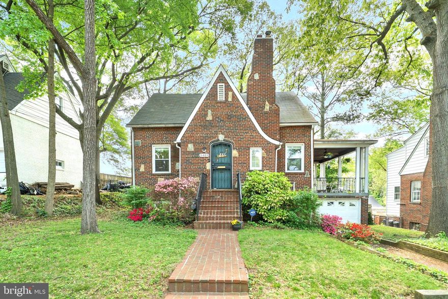 5409 Tilden Road feels like something lifted from the pages of a storybook. With its charming blend of stone and brick, whimsical curved front door, and timeless character, this cottage-style home offers a rare combination of warmth, elegance, and exceptional use of space at every turn.

Step inside to a welcoming foyer with dual coat closets, setting the tone for both function and style. Original hardwood floors flow throughout the main level, leading into an inviting living room anchored by a wood-burning fireplace with a relined chimney—perfect for cozy evenings. Just beyond, a romantic covered side porch with ceiling fans creates an ideal retreat for morning coffee or relaxed entertaining.

The main level also features a formal dining room that seamlessly connects to a well-appointed kitchen, complete with granite countertops, ample cabinetry, stainless steel appliances, gas range and newly installed microwave and disposal. A door off the kitchen opens to a beautifully designed backyard oasis, where a paver patio and expansive fenced yard offer space for gatherings, play, or quiet outdoor enjoyment. A convenient powder room and main-level bedroom add flexibility for guests or home office use.

Upstairs, you’ll find two bedrooms with newer LVP flooring and energy-efficient, whisper-quiet DC ceiling fans. The primary bedroom is notably expansive and includes a walk-in closet, offering both comfort and excellent storage. A stylish full bathroom with a modern shower serves this level, while a large hall closet and attic eave storage room provide even more space.

The fully finished basement expands the home’s versatility, featuring newer luxury vinyl plank flooring, a spacious recreation room, a full bathroom with new vanity and tub/shower combo, and a guest bedroom. The laundry area includes a full-size Samsung washer and dryer, while the utility room provides excellent storage along with a high-efficiency Bosch dual gas/electric hybrid HVAC system (2024) and a new hot water heater (2024).

Completing this exceptional property is a rarely available attached one-car garage with driveway access—an uncommon convenience in this charming neighborhood.

Located in historic Bladensburg, this home offers easy access to the scenic Anacostia River waterfront, nearby parks, trails, and marinas. Enjoy outdoor recreation at Bladensburg Waterfront Park, with opportunities for kayaking, biking, and riverside picnics, all while being just minutes from the Route 1 Corridor, Washington, D.C. and major commuter routes.