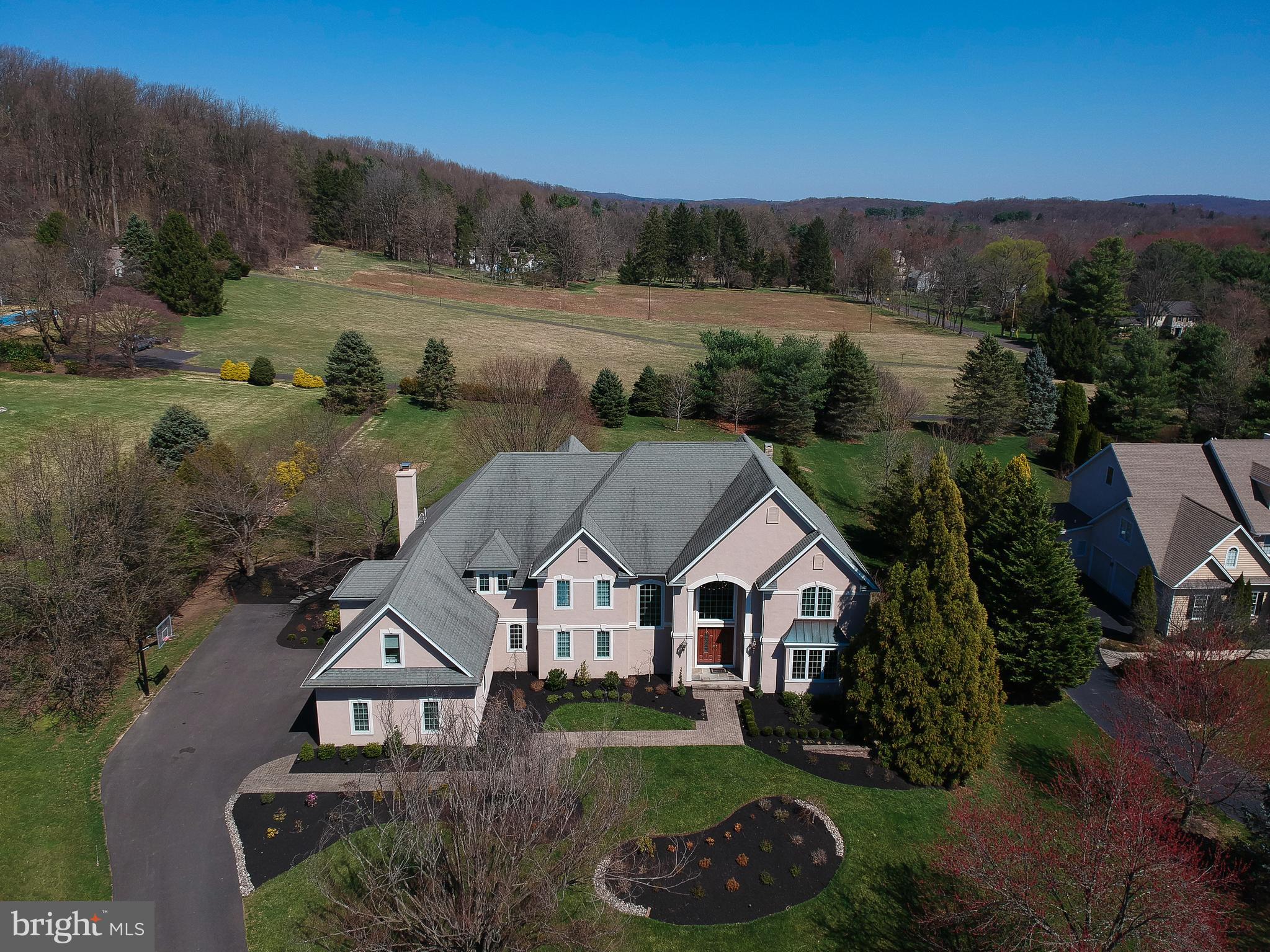Welcome home to this magnificent 5,000+ SqFt Zaveta Built home on a 1+ acre lot that will meet every need and desire that you have. As you enter, find the welcoming two story foyer that's beaming with natural sunlight from the oversized windows.The large foyer opens to the dining room with wainscoting and to the living room featuring a marble gas fireplace that both look straight through to the beautiful backyard. The large library/study has built-in bookcases and french doors.The spacious kitchen has room for six stools at the center island and boasts granite countertops and stainless-steel appliances along with a huge walk-in pantry. The sun-filled breakfast room has a door leading to the rear yard and is open to the two-story family room with two walls of windows letting in lots of light. The stone fireplace is the focal point in this spacious room. Also on the main level of the home is a butler's pantry with a sink and wine fridge off of the dining room. The half bath and a full laundry room with a sink, countertops, cabinets and a closet with plenty of storage space complete the first floor. Take the front or back staircase to the upper level where you will find the master bedroom suite with a coffered ceiling and triple window looking out to the serene backyard. The master bath has two vanities, one with double sinks and the other is a makeup vanity with room for seating and built in shelving. Enjoy the oval jetted soaking tub and large stand alone glass-enclosed shower. Also, find a large walk-in closet with pull-down stairs to a floored attic space for more storage. As you cross over the catwalk, you will encounter four more bedrooms. One of the princess suites has its own updated bathroom with a glass-enclosed shower featuring beautiful new tile work. The Jack and Jill bedrooms share a bath with two sinks and a nicely sized glass-enclosed shower featuring detailed tile as well. The oversized fifth bedroom is also a princess suite with its own full bathroom, large walk-in closet and laundry shoot just outside in the hallway. Take the back staircase down to the kitchen area where you will find the steps to the lower level with extra high ceilings. Here you will enjoy the sun-filled party room/rec room with a wet bar and boasts gorgeous granite countertops. Find a set of sliders to the rear yard in this space. You will also encounter a private theater room with built in surround sound, a half bath, sauna and a full In-Law/Au-pair style suite/apartment. This suite has a full kitchen with full size appliances, a living room with full windows and a 6th bedroom with its own walk-in closet, full bath and sliders to the private backyard. This area could also be an extension of the entertainment space if you prefer. With all of this, there is still storage space for those items not in regular use. When you step outside, you will be in awe of the extensive outdoor living space. First enjoy the hot tub and patio area off of the lower level and then make your way to the newer covered pavilion with an outdoor kitchen, bar area, full wood-burning fireplace and lots of room for seating. The pavilion also features two flat screen tvs along with surround sound speakers. Attached to the pavilion is a well thought-out built-in sitting area with a fire pit to enjoy the great outdoors. This home with a 3 car side load garage is unique with plenty of space to entertain family and friends and sits within the much sought-after Central Bucks School District. This fabulous Buckingham location is close to shopping, restaurants, downtown Doylestown Borough and commuter routes to NY, NJ, and Philly.