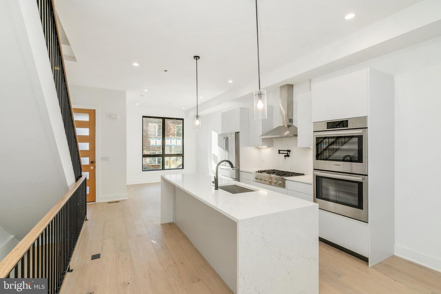 **4.99% interest rate for Artist Village buyers! Details below.** This is the LAST home available in Phase 1 at Artist Village!! Welcome to Artist Village, Philadelphia's brand new exclusive community of stately residences. With its prominent location at 17th & Bainbridge Streets in the heart of the historic Graduate Hospital, this unique enclave of homes will transform an entire city, bringing new life to a treasured neighborhood. Developed by The Regis Group & Ingerman Company, the first phase of Artist Village offers twelve 2,600 - 3,200 SqFt townhomes running parallel down 17th St and Colorado St. Each residence has been expertly designed, by JKRP Architects, with a layout that perfectly blends form with function. Every home will have private 1-2 car garage parking, an expansive roof deck - three outdoor spaces total, a tax abatement, elevators in the 17th Street homes and smart-home technology throughout plus the homes on 17th Street each have an elevator! A handsome brick facade greets you at the home's exterior. Once inside, you'll discover a completely open main level with a living room and dining area filled with natural light from tall windows. The fireplaces are sheet rocked and painted for the buyer to customize on their own later if desired. The stunning chef's kitchen, adorned with top-of-the-line appliances, custom cabinetry, and designer finishes, is sure to become the heart of the home! The lower level has the all-important 1-2 car garage parking and a bonus space ideal for a home theater, playroom, or gym. The second level has two bright bedrooms, two full bathrooms, and a conveniently located laundry closet. The primary suit covers the entire third level, acting as a private retreat. There's a large bedroom with great natural light, a custom walk-in closet with space to share, and a luxurious bathroom fitted with a double vanity, soaking tub, rainfall shower, and a water closet. Topping off this amazing home is a one-of-a-kind bi-level roof deck! With a powder room and wet bar equipped pilot house, tons of space to spread out, and mesmerizing city views, this is an entertainer's paradise! Not only is Artist Village a fantastic development, but it's also in an equally fantastic neighborhood. This highly sought-after Graduate Hospital location earns a WalkScore of 97! Nearby, South Street is lined with local restaurants, shops, and markets. Fine dining, luxury shopping, and lively entertainment can be found in neighboring Rittenhouse Sq, plus Target, Sprouts Farmers Market, and Wine & Spirits are less than a 10-minute walk away. This central location provides easy access to Broad St, Washington Ave, Jefferson Hospital, Pennsylvania Hospital, University City, and I-76. Artist Village presents a rare opportunity not to be missed. The time is now to reserve your home, customize your finishes, and plant your roots in Graduate Hospital's next chapter. The top floor flex space can easily be converted into a fourth bedroom; a door can be added for privacy. Taxes and square footage are the responsibility of the buyer to have verified. Association fees are TBD. *Photos are of a similar home. Photos/renderings are for marketing purposes only and may not portray actual finishes. **Special interest rate from preferred local lender is part of a 2-1 buy down that the seller will pay for! The rates change daily, check with listing agent to confirm up to the minute rate.**