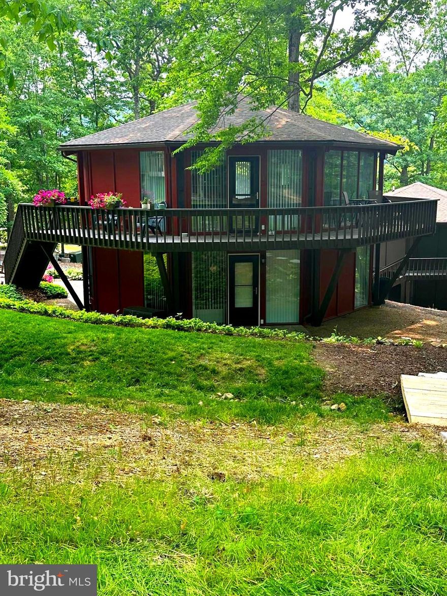 Looking for a place to escape too or permanent residence, this unique, octagon home has all that! Features a unique conversation piece a spiral stairway, large floor length windows in every room of the home. Open kitchen and living space, kitchen offers oak cabinetry with a pantry and island with a additional storage, master suite with a walk-in closet, private master bath and beautiful Bamboo flooring. Spiraling down to the main floor is the second bedroom w/bathroom and a bonus room that can be used a 3rd bedroom with an outside entry way. Well maintained and lots of beautiful perennial's adding to the landscaping. Nice wrap around porch over looking the Omni Bedford Springs Resort & Spa, Golf Course just within walking distance to enjoy the amenities of the Resort. Possibilities are endless, Air B & B, Retreat/vacation home, walking trails adds convivence to the downtown shops and restaurant's!! There is room to add a garage or add on with the oversized lot. Call for your tour today!