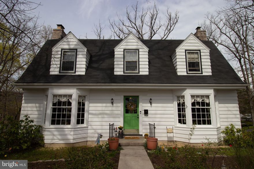 This Dutch Colonial built in 1948, is a Better Homes & Garden design. The bones of this house are solid and reflect strong craftmanship. Located steps from the historic Berkeley Springs State Park gives the owner the option of walking to town for shopping and restaurants or to the high school to catch a game under the Friday night lights. In the fall, you can stroll down to the Apple Butter Festival and have easy front row seats to the parade and coveted access to the festival without the worry of parking or traffic. The quaint surrounding neighborhood allows for quiet streets to walk the dog or to let the kids ride their bikes.

Four large bedrooms and three floors of living allows for lots of customizable living space. The walk out basement has ample storage, room for an in-law suite and a full bathroom. A large laundry space has a convenient laundry chute from the third floor. The main living space has a large, bright and airy living room with a fireplace. The dining room has a matching bay window which looks out onto the mature rhododendrons and ancient oak trees. An updated kitchen with pantry boasts eight windows overlooking the side and back yards. Off the kitchen is a delightful screened in porch and deck giving access to the outside and a shady place to relax and grill.

The third floor offers four bedrooms with generous closets and a recently updated bathroom. The best surprise of the house is the treetop balcony which allows scenic views of the castle and downtown Bath. A sweet hidden spot to rest among the trees or stargaze.

The wooded lot is filled with nature’s gems. Towering oak trees which shade the house and yard in the summer, gorgeous young maple trees that turn golden in the fall, and fragrant dogwood trees that bloom pink in the spring; provide a bounty of birds and squirrels for your entertainment. This home is well loved and gives respite from the busy day to day.