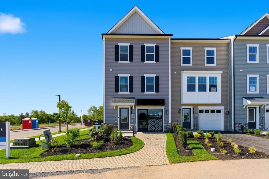 *OFFERING CLOSING ASSISTANCE FOR PRIMARY RESIDENCE WITH USE OF APPROVED LENDER AND TITLE.* MOVE-IN READY! Welcome to Table Rock Terrace, where modern design, thoughtful upgrades, and low-maintenance living come together just minutes from the charm and history of downtown Gettysburg. Nestled in a picturesque, tree-lined neighborhood near Gettysburg Area High School, residents enjoy a peaceful setting with a community walking trail, plus included services like trash, snow removal, lawn care, and landscaping—making this one of the most effortless and desirable places to call home. This beautifully designed York II Garage townhome offers exceptional space, style, and an abundance of natural light throughout. From the moment you step inside, the entry level greets you with large windows and a glass door that create a bright, welcoming first impression. A versatile living space, full bathroom, and access to the one-car garage make this level ideal for guests, a home office, or additional living. The main level is truly the heart of the home, designed for both everyday comfort and entertaining. Warm LVP flooring flows throughout the open-concept layout, while a stunning triple window at the front of the home serves as a standout feature—flooding the space with natural light and adding architectural charm. Additional rear windows and a glass door off the morning room continue the bright, airy feel throughout. The gourmet kitchen is equally impressive, featuring 42” rich walnut cabinetry, a deep apron-front sink, stainless appliances, and upgraded pendant lighting. At the center of the space is an impressive 8.5-foot kitchen island—perfect for gathering, prep, and entertaining. The glossy white tile backsplash adds a clean, modern contrast, while the elegant Frost White quartz countertops offer a subtle shimmer that beautifully reflects the natural light. The morning room extension adds valuable square footage, creating the perfect space for dining, relaxing, or entertaining. Upstairs, the primary suite offers a private retreat with a spacious layout, walk-in closet, and a luxurious en-suite bath complete with a freestanding soaking tub, separate tile shower with frameless glass door, and double vanity. Two additional bedrooms, a full hall bath, and a conveniently located laundry area complete the upper level. With a rare combination of space, natural light, and upscale finishes—plus the added benefit of low-maintenance living in a highly sought-after community—this home truly offers the best of comfort, convenience, and style.