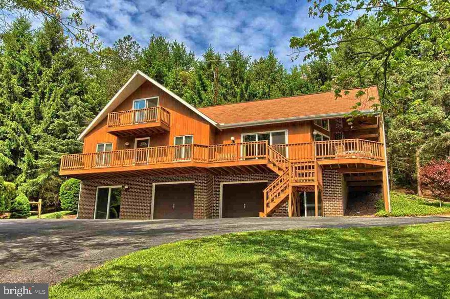 BUY A LIFESTYLE, own a private 7+ acre oasis away from the noise. Relax & entertain on your wrap around deck overlooking the pond & stream, melt away the stress in your hot tub. Bring your horses & inside enjoy, modern updates like granite, stone FP, vaulted ceilings, wood & tile floors,newer furnace & c/air. Pride of ownership streams through this 3 BR 2.5 BA